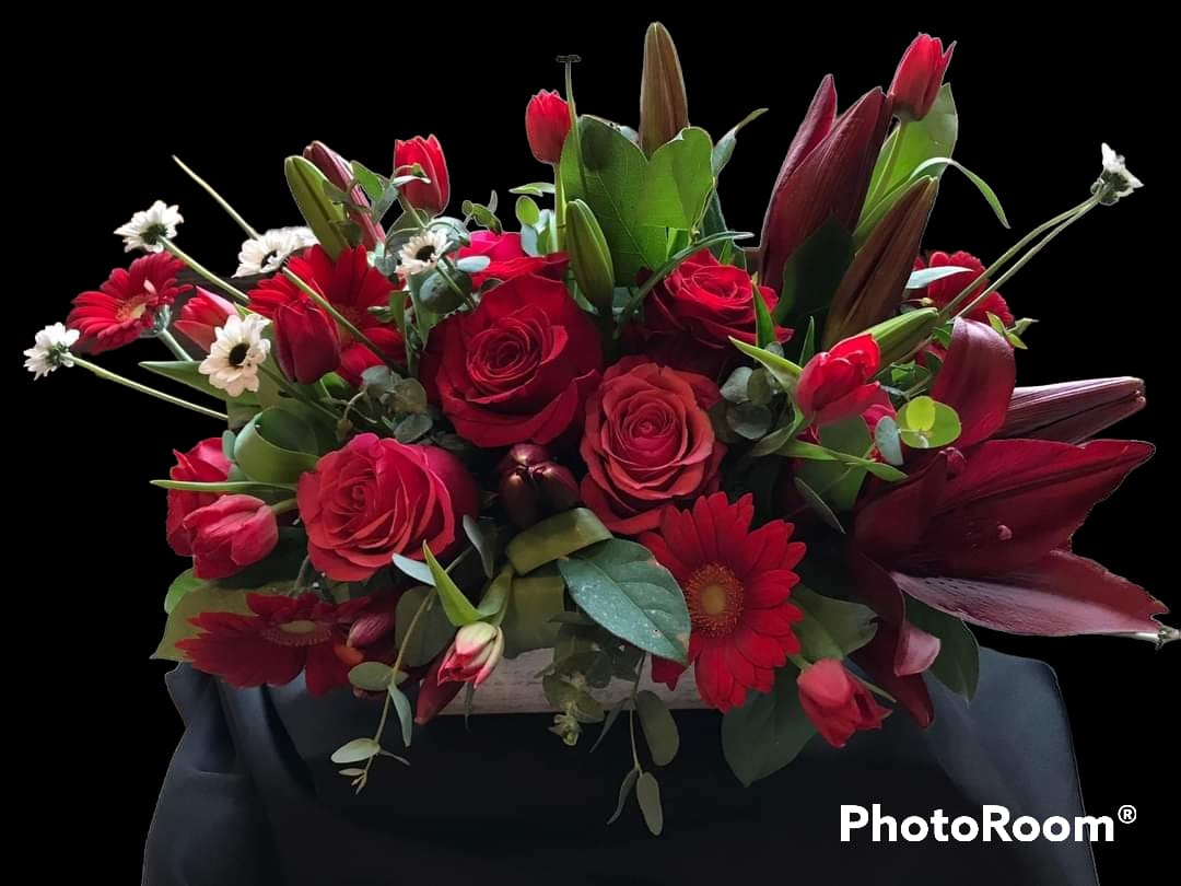 Red Delight - This beautiful box of flowers, filles with roses, lilies, gerbera, tulips in all shades of red and a touch of white daisy is sure to please the finicky and the the picky! Super classy and classic. If you have any doubt, this is the way to go!!