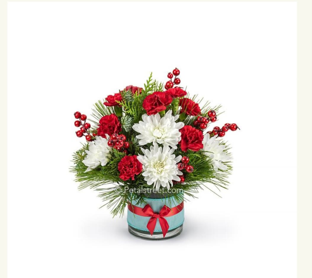 Traditional Christmas  - A very traditional arrangement filled with red and white blooms, evergeens, in a beautiful ceramic container!! Containing carnations, roses, berries, evergreens all ready to send to the special someone
