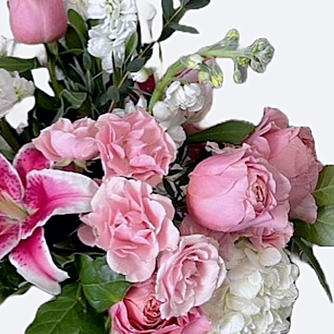 Heart's Harmony - A Bouquet of Elegance and Grace &quot;Heart's Harmony&quot; is the perfect bouquet for someone special, featuring fresh-cut flowers in soft-hued pastel shades that create a stunning visual display. This arrangement includes creamy whites and pinks, with blooms such as scented stock, hydrangeas, garden roses, and petite roses, all accented with natural foliage. Deluxe Size Shown: The arrangement measures 19” high by 12” wide, offering a generous and impressive display. Pastel Perfection: The soft hues provide a calming and elegant aesthetic, ideal for any occasion. Dynamic Selection: Flower choices may vary on the day of delivery, ensuring a fresh and unique bouquet every time. Whether you're celebrating a special occasion or simply want to brighten someone's day, &quot;Heart's Harmony&quot; from Elizabeth's Garden is a beautiful choice that conveys warmth and affection. Enjoy the timeless beauty of this exquisite floral arrangement.