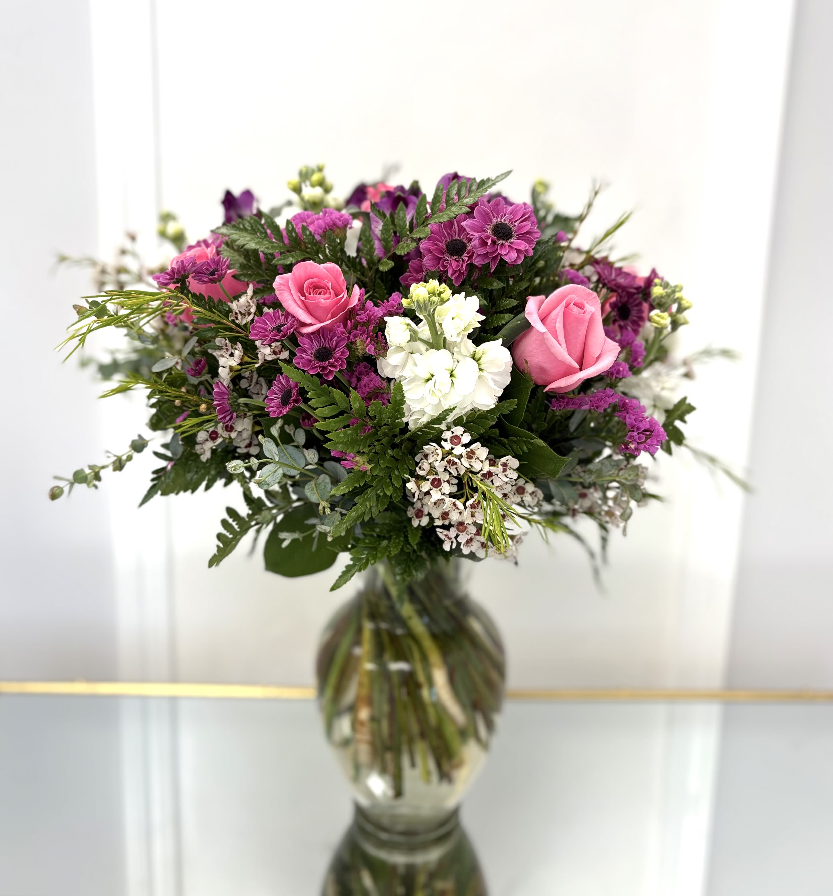 Pink And Purple Mix By VLM Flowers - This vase arrangement consists of mixed flowers with pink and purple colors tach up of white. 