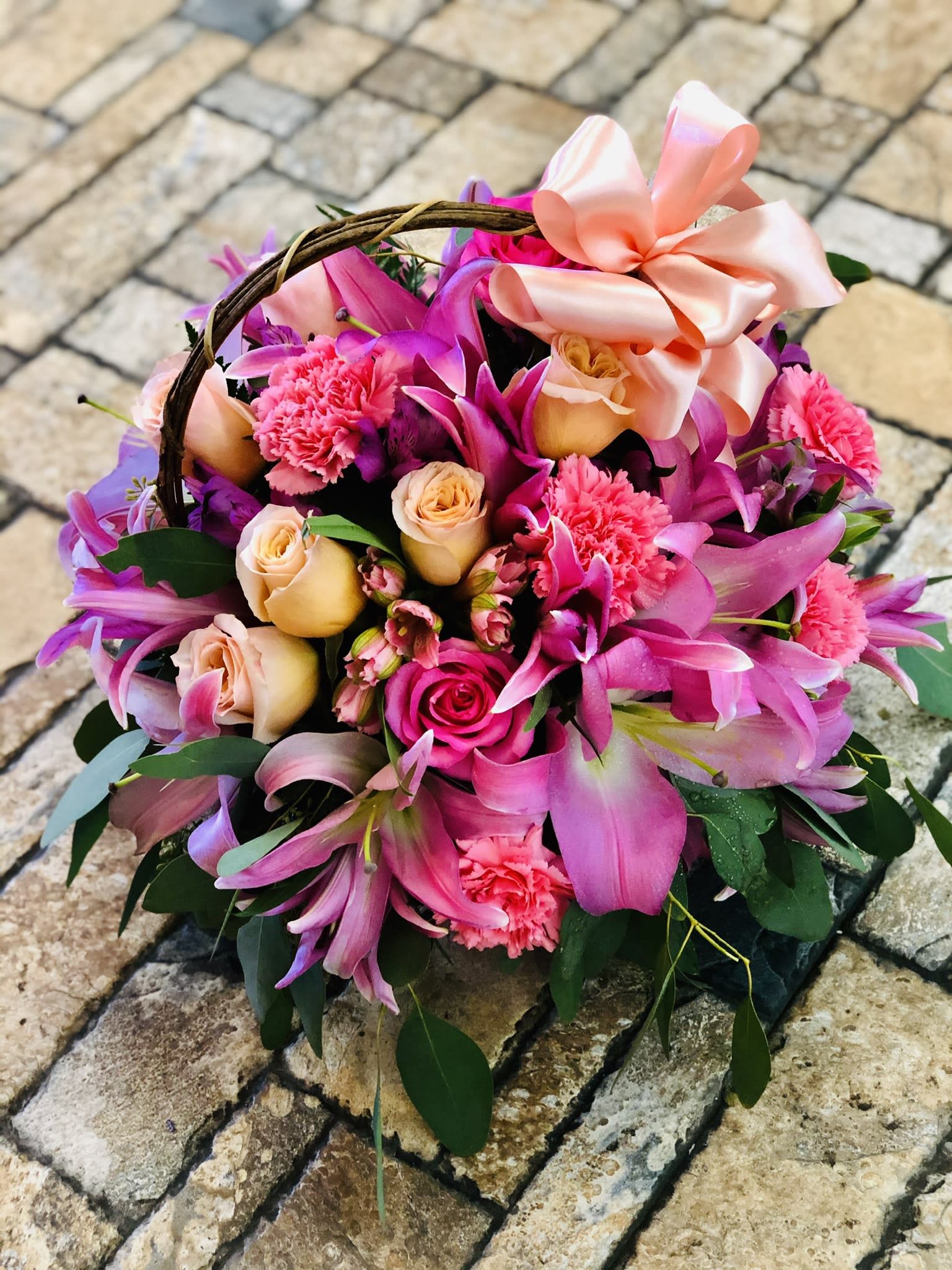 Pink Fantasy Basket - A fanciful basket full of lush blooms, Pink Floral Fantasy is a treat for the special people in your life! Stunning Stargazer lilies, roses, and other fresh blooms spring forth in a design that's fit for royalty. Liven up their home with these gorgeous flowers today! The container may vary depending on availability. Bouquet may be sent in a basket, a metal or a plastic container.