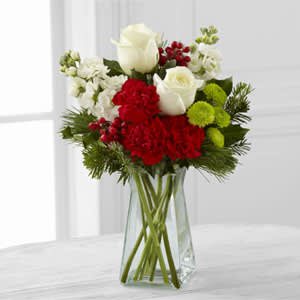 Eckert Florist's FTD Christmas Peace Vase Bouquet  - The FTD® Christmas Peace™ Bouquet captures the elegance of the season at every turn. Assorted holiday flowers and greens are arranged perfectly in a clear glass vase to create a gift that extends warm wishes for a season of peace and togetherness. Flowers, foliage and vase will vary.