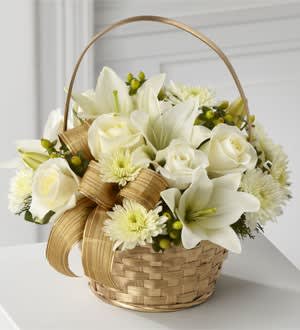 Eckert Florist's FTD Winter Wishes Bouquet - The FTD® Winter Wishes™ Bouquet is a snow-filled display of seasonal elegance. White fresh florals create winter magic seated in a gold basket and accented with green winter foliage and a gold designer ribbon, making this a wish for a season abundant in beauty and togetherness. *Flowers and ribbon may vary.