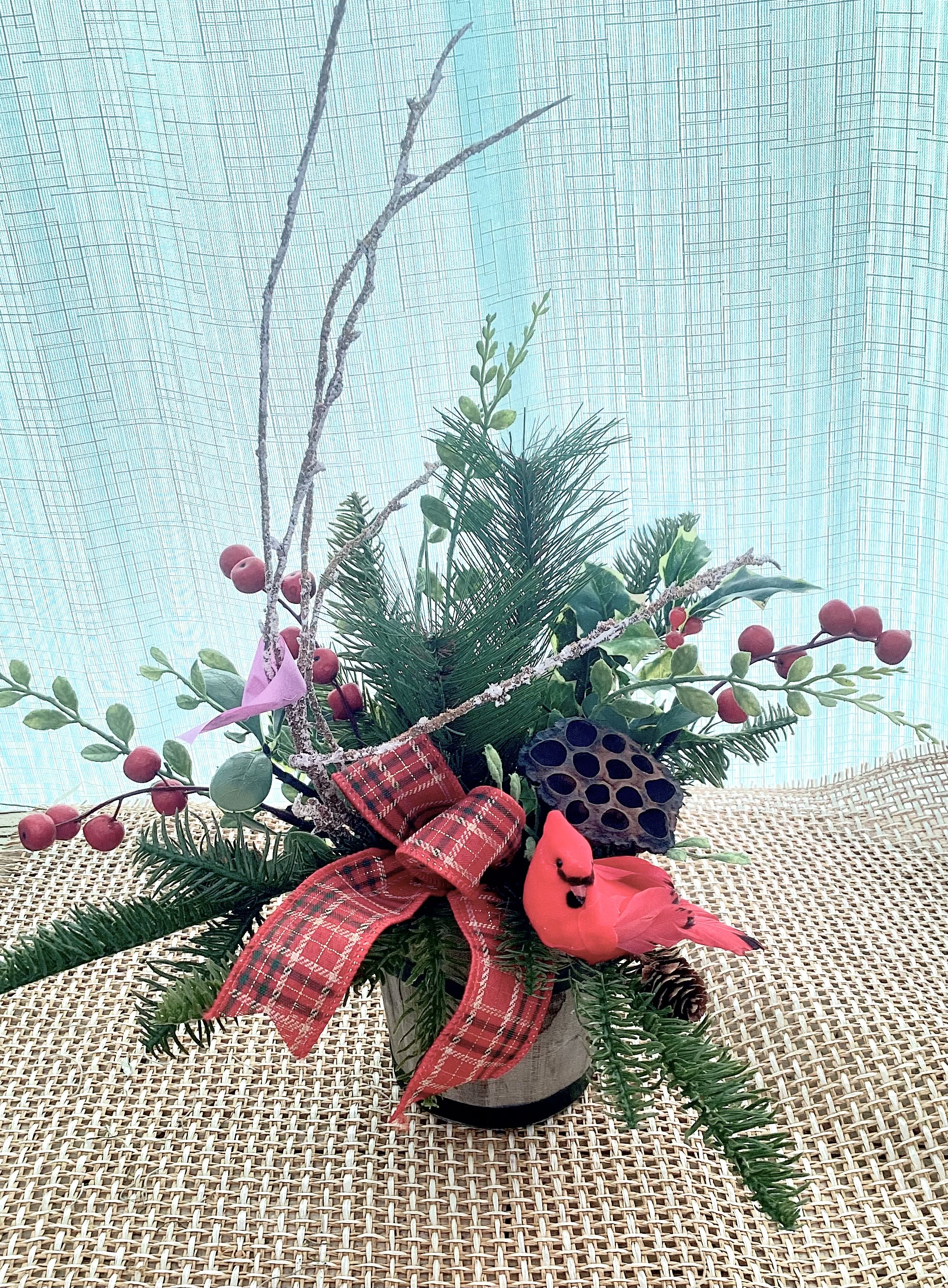 Holiday Cardinal Permanent Arrangement  - A holiday arrangement decorated with greenery and a Cardinal in the center