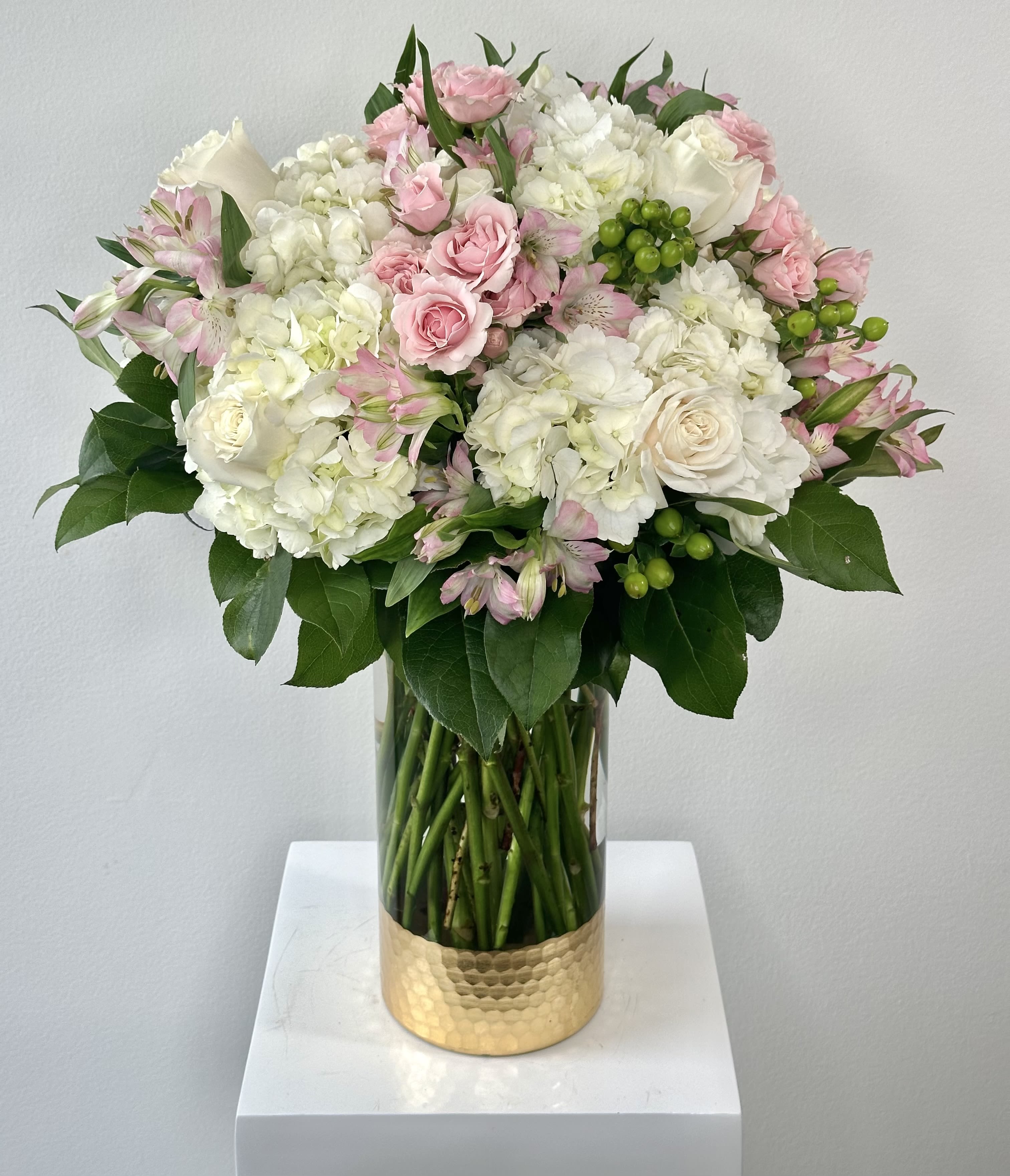 Extravagant Parisian Stroll - Introducing the Extravagant Parisian Stroll, an opulent upgrade to our best-selling Parisian Stroll flower arrangement, designed to capture the timeless elegance of a romantic walk through Paris. This luxurious bouquet elevates the classic charm with a stunning blend of white hydrangeas, delicate pink and white roses, vibrant hypericum berries, and charming pink alstroemerias. Standing at an impressive 23 inches tall and spanning 16-17 inches wide, this arrangement makes a bold statement, perfect for weddings, anniversaries, or any special occasion. Handcrafted by expert florists, each bloom is carefully selected to ensure freshness and beauty, creating a breathtaking centerpiece that exudes sophistication. Ideal for those seeking luxury floral arrangements or romantic bouquets, the Extravagant Parisian Stroll brings Parisian flair to your event or home. Order now to experience this premium flower arrangement and elevate your gifting with unmatched elegance. Perfect for same-day delivery in Orange County. Shop the best in floral design today!