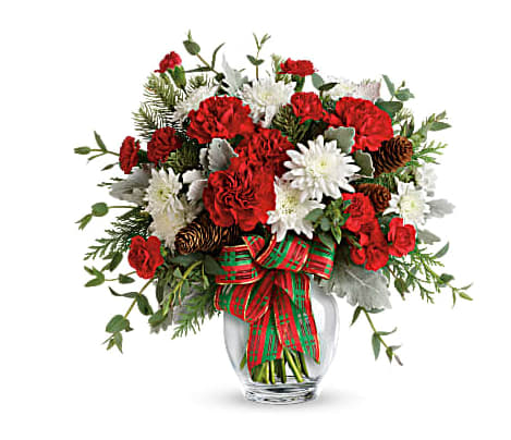 Teleflora's Holiday Shine Bouquet - Make their season bright with this fun bouquet of Christmas blooms, hand-delivered in a glass ginger jar and accented with a shimmering holiday plaid ribbon. This bold bouquet includes red carnations, red miniature carnations, white cushion spray chrysanthemums, flat cedar, noble fir, dusty miller, parvifolia eucalyptus, small pinecones and wired ribbon. Delivered in a glass ginger jar. Orientation: One-Sided