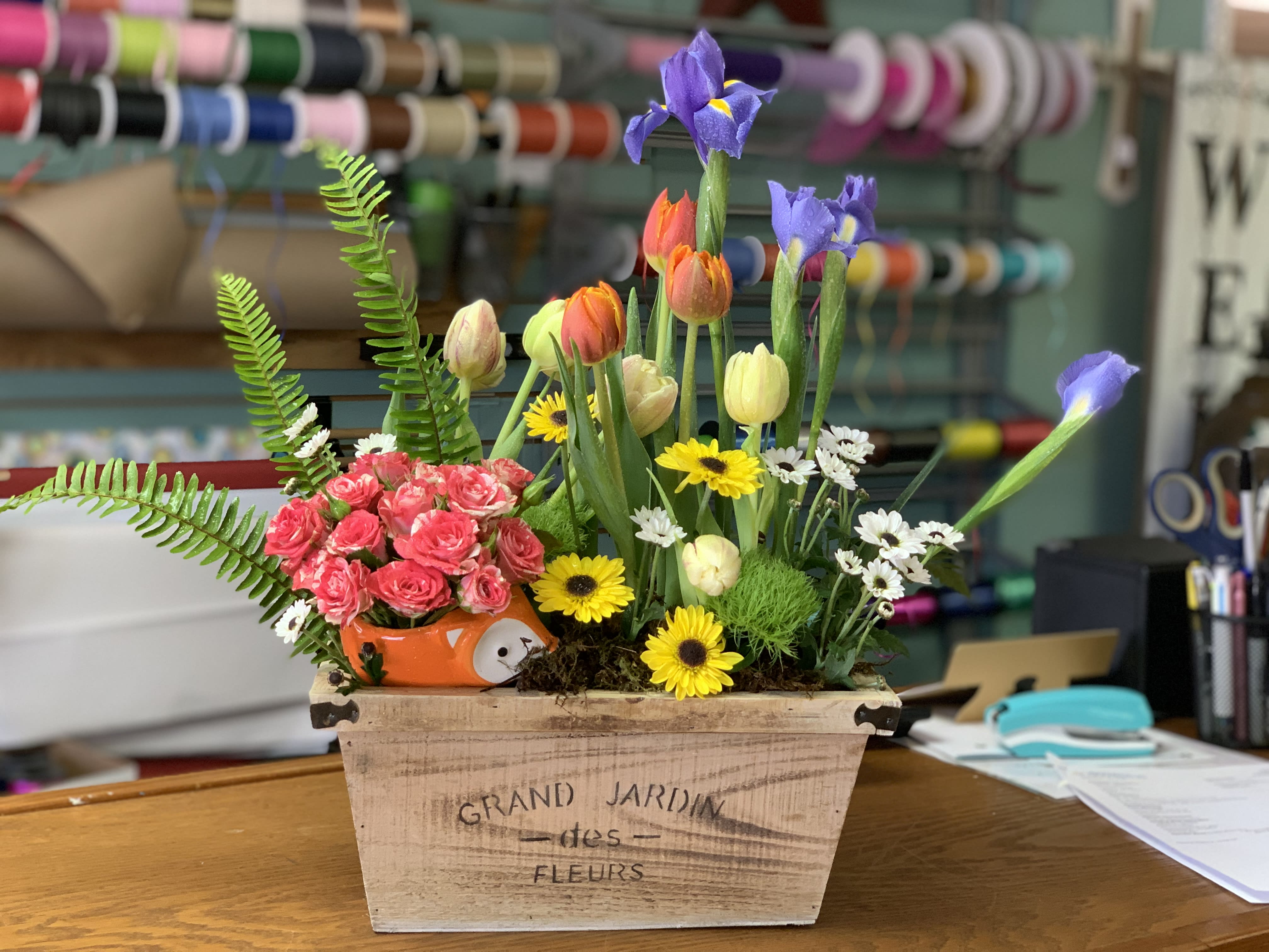 Enchanted Garden - This wonderful arrangement is displayed in a wooden box with an assortment of seasonal flowers and has a hidden critter which also holds flowers. This arrangement will surely put a smile on someone's face.