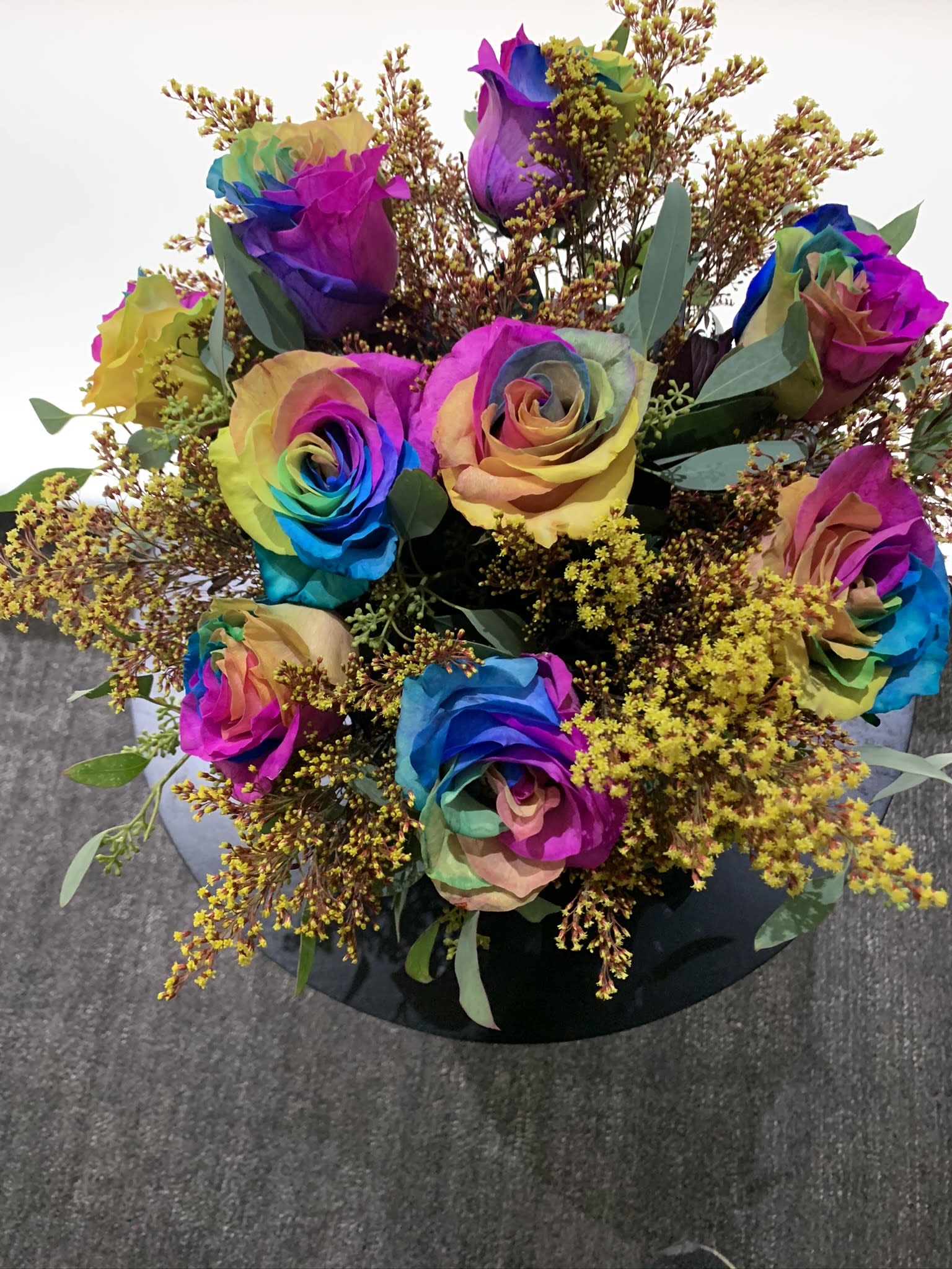 Rainbow Chic Box  - Dozen rainbow   roses set in black  Conteiner accent with solidago and greenery