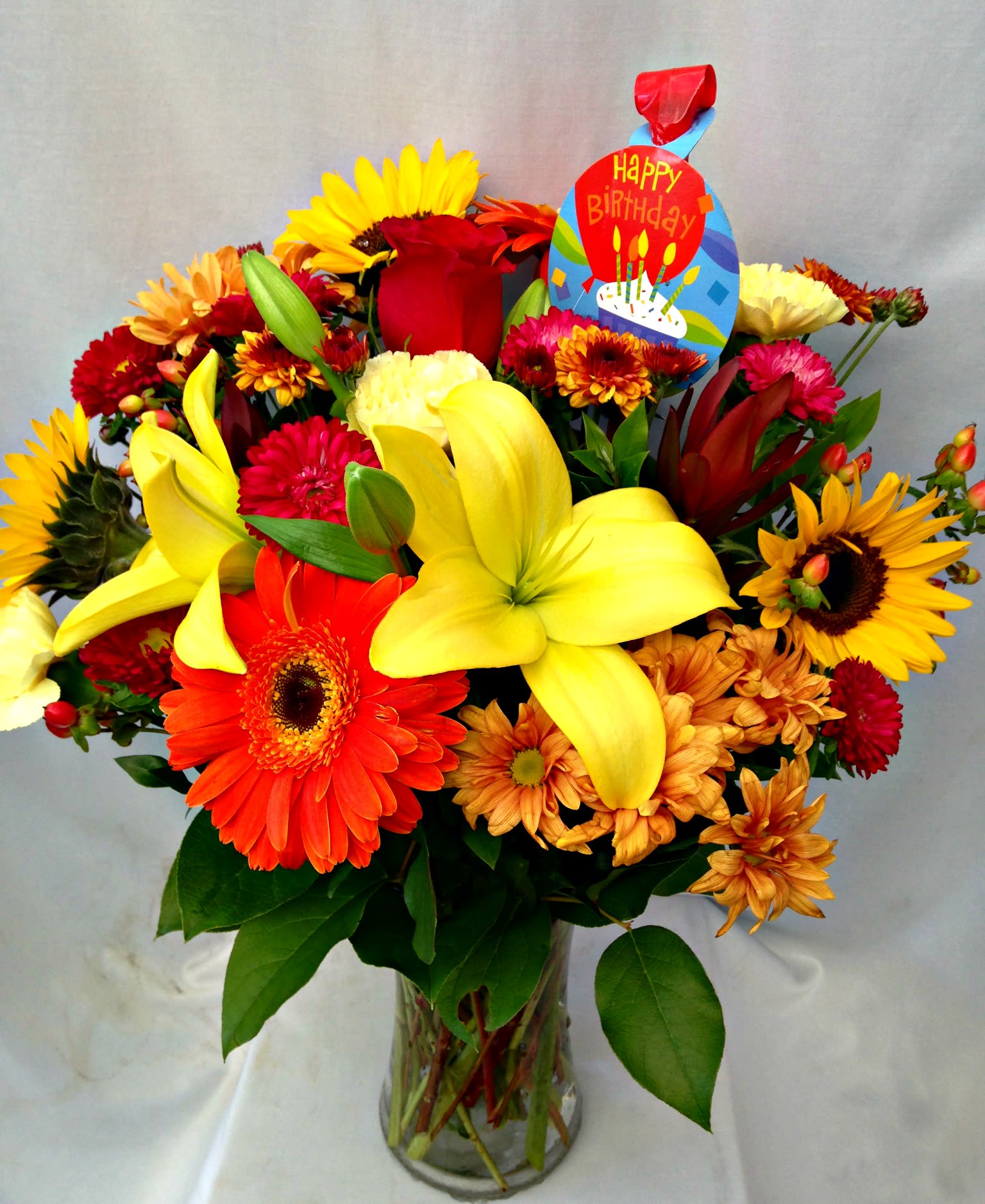 Happy B-Day to you - A gathering of beautiful blooms in the colors of red, yellow, and orange.