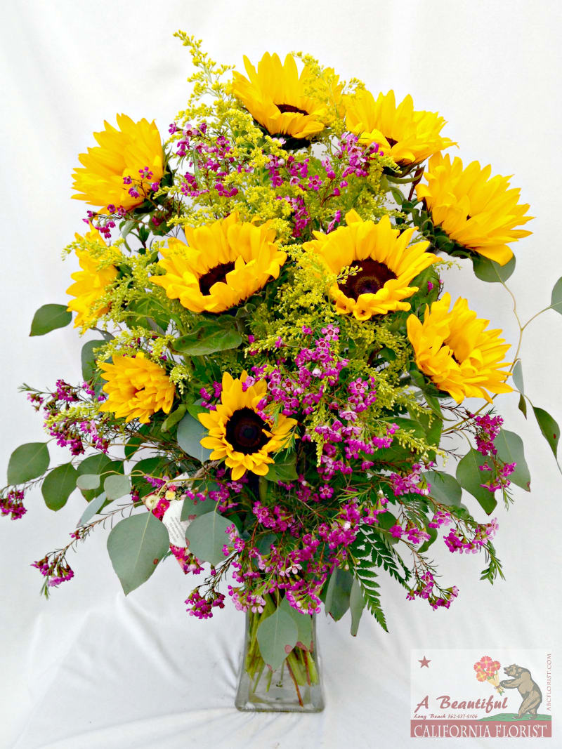 California Garden - Sunflowers, Solidago and Pink Wax Flower - California Garden arrangement of bright Sunflowers, golden Solidago and accented by pink Waxflower. A wonderful arrangement for almost any occasion. Approximate size is 14&quot; Wide x 20&quot; Tall. Same day delivery at Long Beach's favorite florist, A Beautiful California Florist!