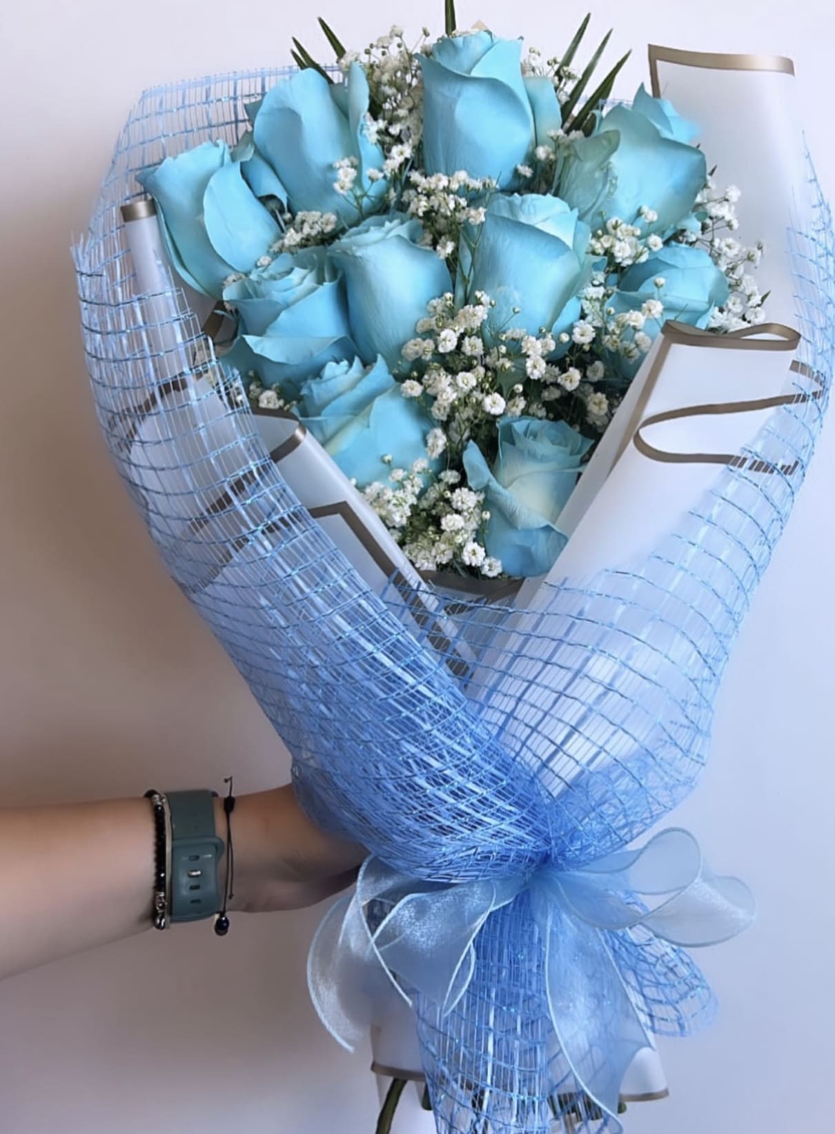 10 Baby Blue Roses in A Hand Bouquet - Hand Bouquets DO NOT come with a vase!  Flowers may have to be substituted.. But you should recieve the same overall color and theme. 