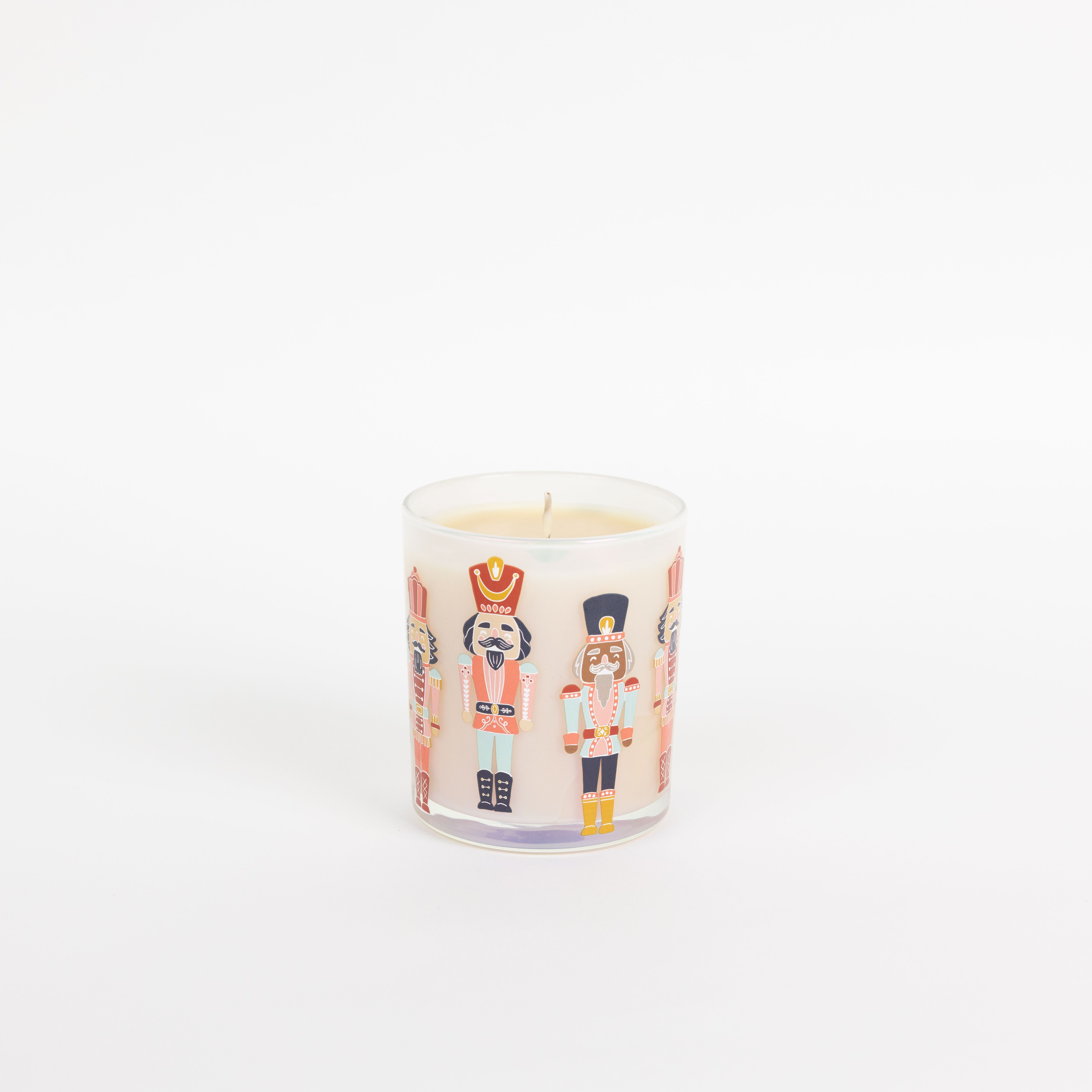 Nutcracker candle (Sweet Grace) - Bring the holiday spirit to life with Sweet Grace Collection Candle #066! This festive candle features playful nutcracker decals on an iridescent glass jar and is filled with a soy-blend wax infused with our best-selling Sweet Grace fragrance. With a burn time of up to 72 hours, it’s perfect for spreading warmth and cheer all season long. Light it up and let the magic of Sweet Grace fill your space!
