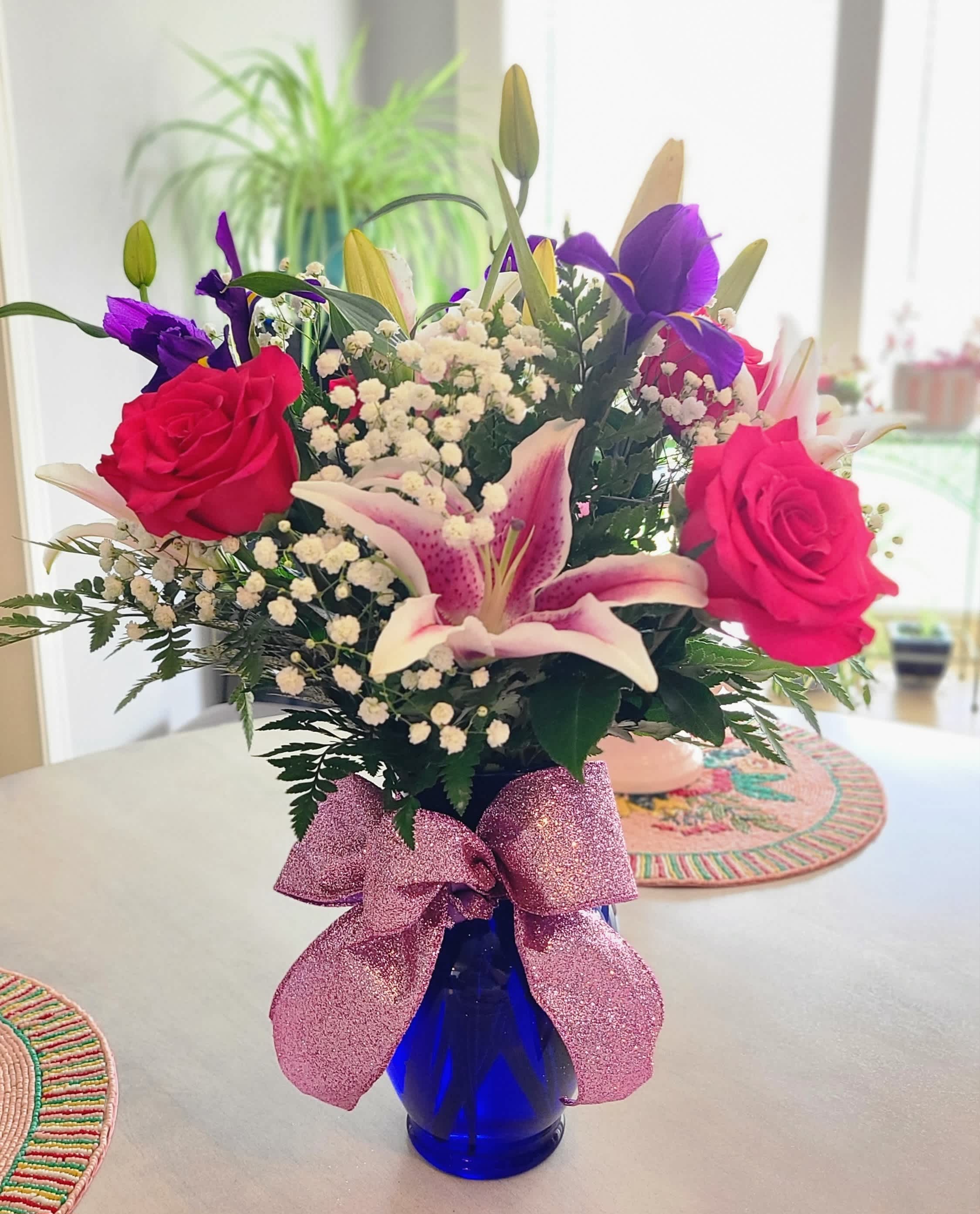 Lady Attitude  - For the sassy, classy lady, this fresh bouquet features, lillies, roses, and irises.  This bouquet comes in class vase and can be upgraded to a colored glass vase.