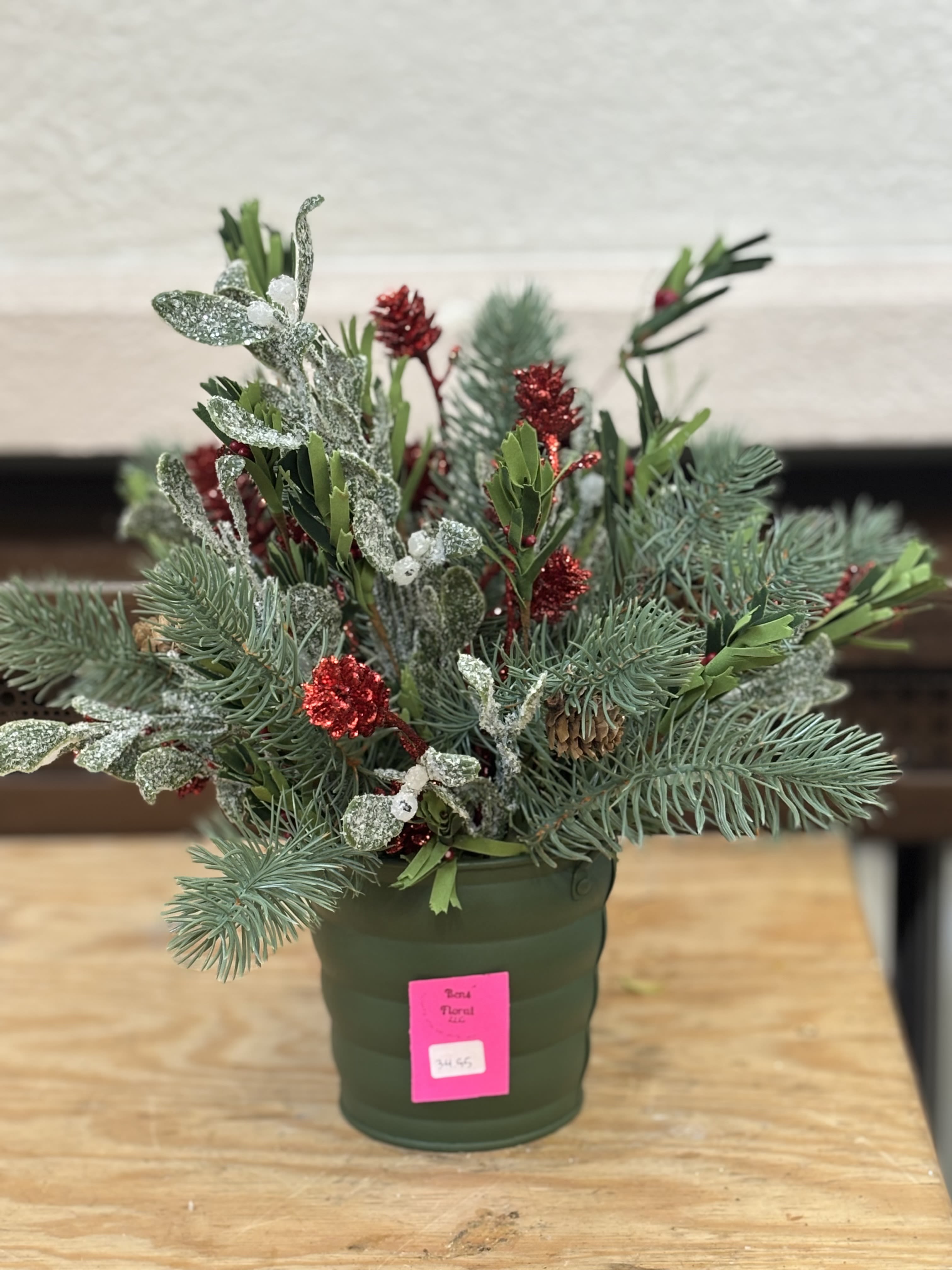 Artificial Christmas Tin  - A pine artificial arrangement in a green tin bucket. 