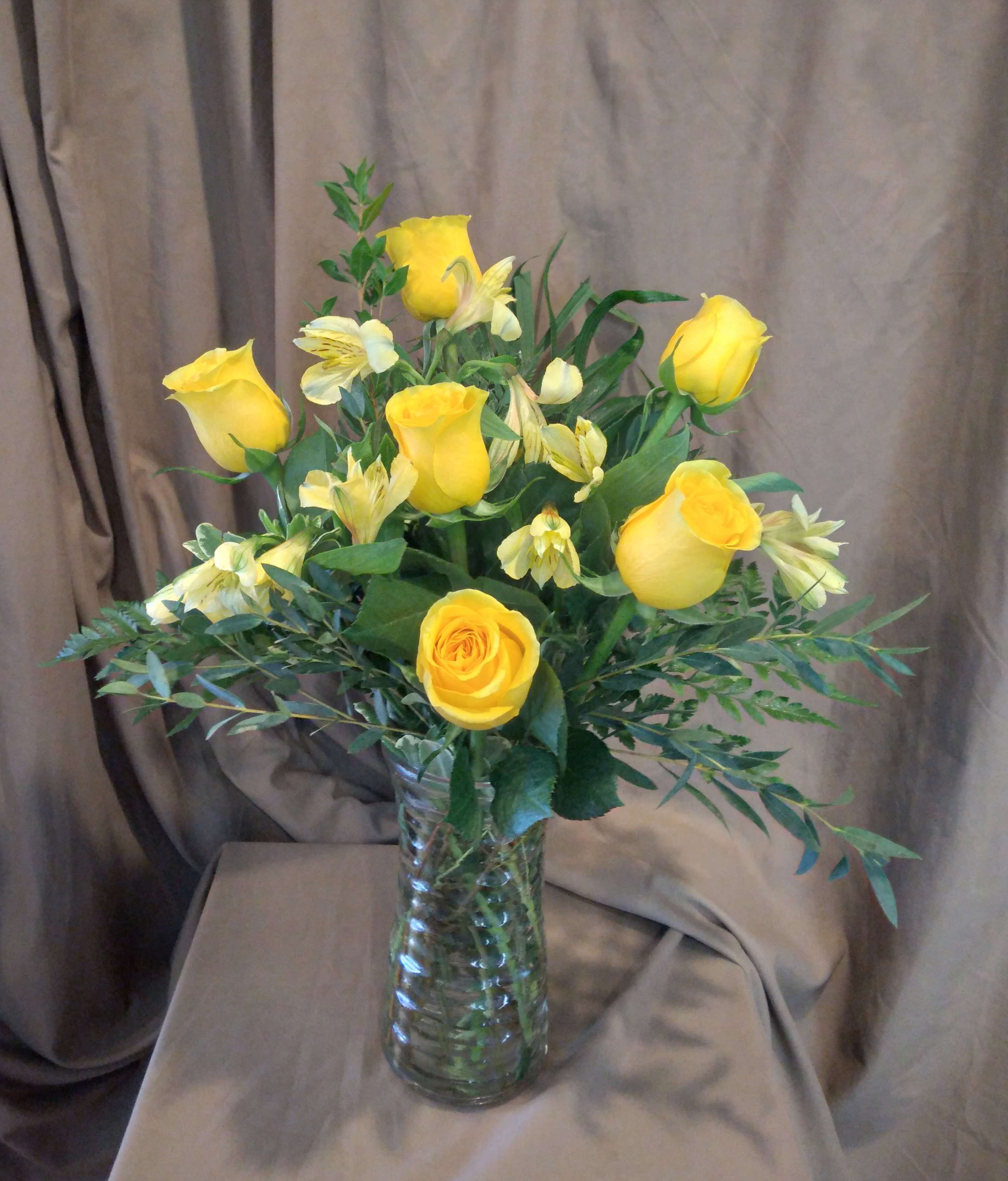 Yay! Yellow Roses ~ Flower A Day - Half dozen (6) yellow roses arranged with accent flower and a variety of foliage in a clear glass vase (vase style may vary).