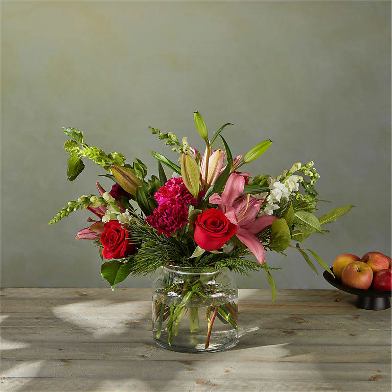 Christmas Star Bouquet - White snapdragons and surprising pink hybrid lilies offer a subtle twist to the classic holiday palette in a bouquet that rings with splendor.