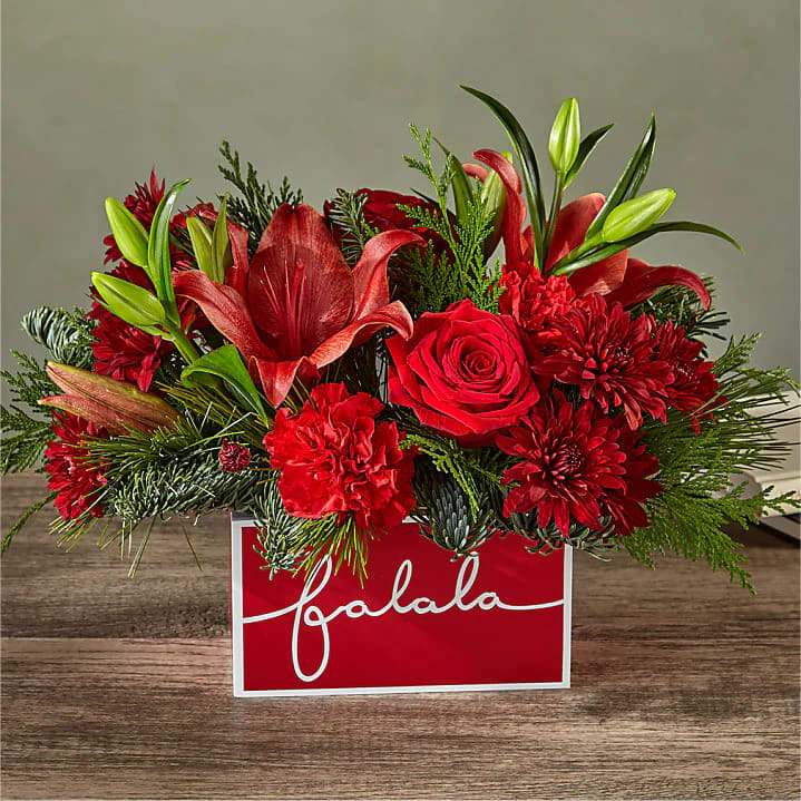 Yuletide Carol Bouquet - Deck their halls with this lively bouquet studded with surprising red lilies and a jolly keepsake box that captures the joy of the season.