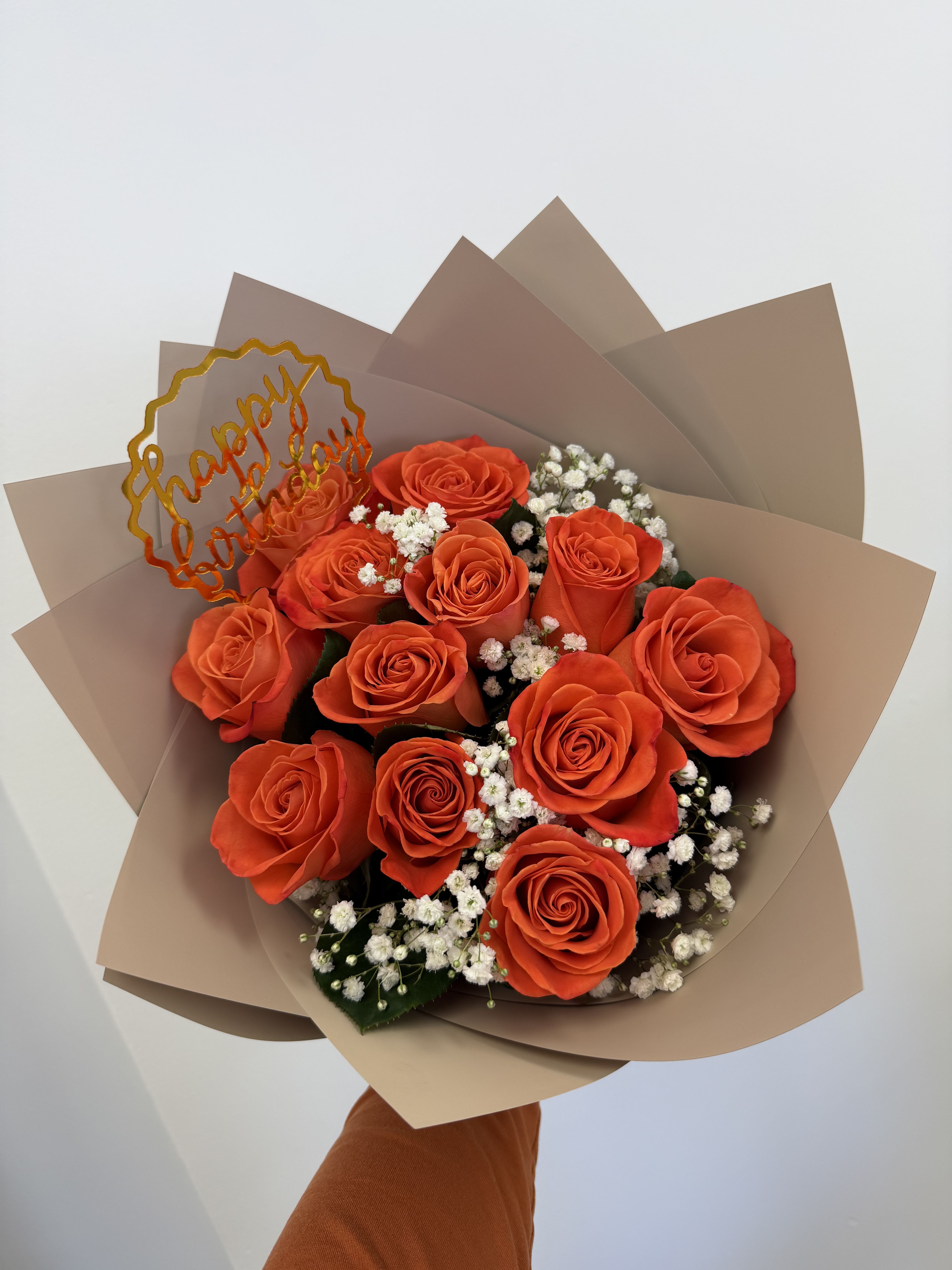 Orange Crush Bouquet  - A burst of color and joy. Our Orange Crush Bouquet features 12 bright orange roses paired with delicate Baby’s Breath, beautifully wrapped in our waterproof floral wrapping paper. Perfect for birthdays, thank-yous, or just to brighten someone’s day. A modern, cheerful design—crafted with love by Magenta Floral. 