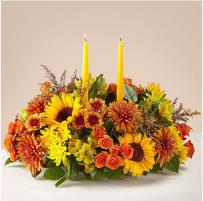 Thanksgiving Centerpiece II - Bring Warmth and elegance to your thanksgiving table with this stunning centerpiece of sunflowers, orange roses, golden mums and fresh seasonal accents.