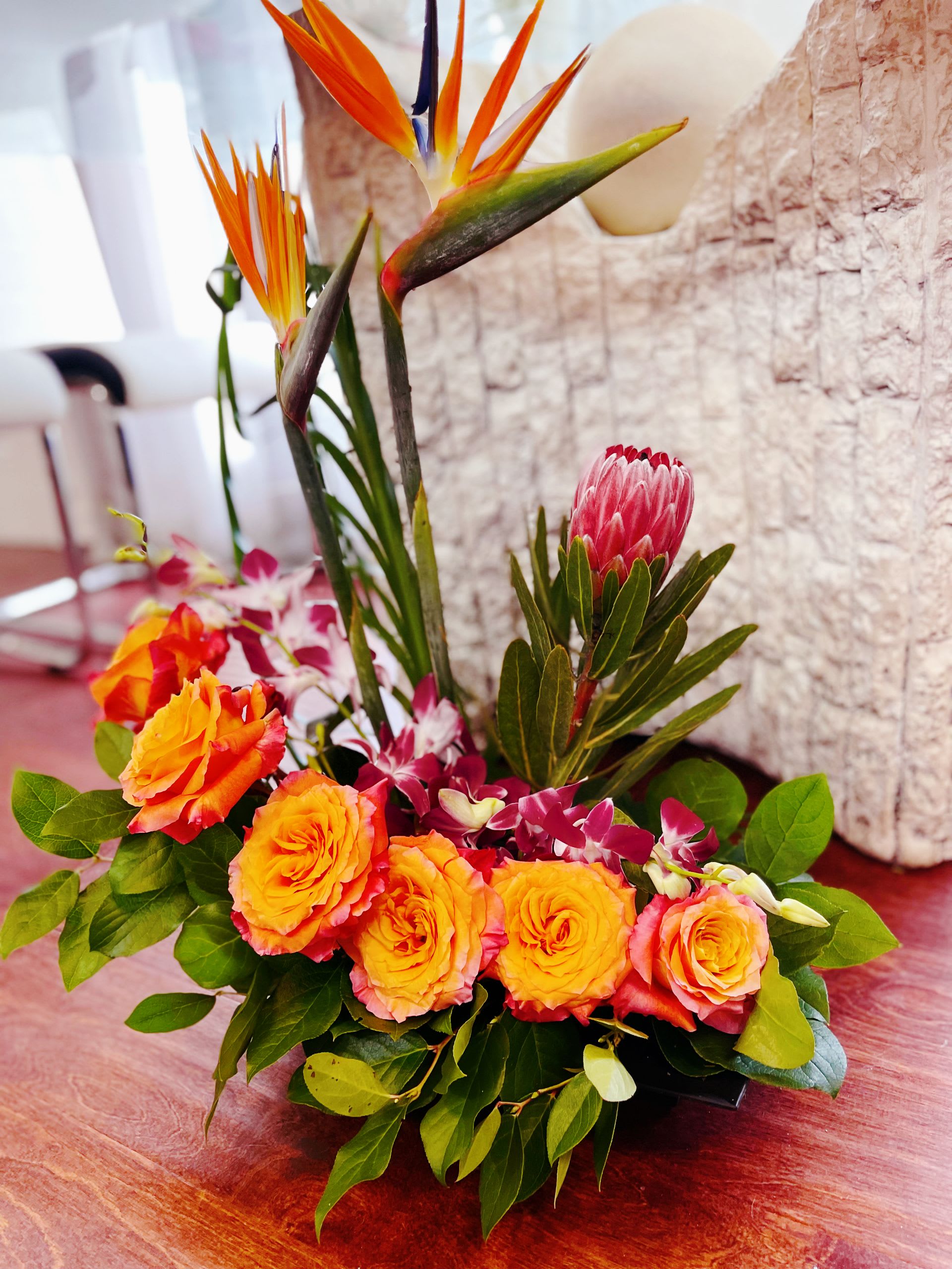 Tropical Pre order 1 Day before - Please Pre order one day before.  A vibrant celebration of color and exotic beauty, this tropical arrangement bursts with life and energy, Birds Paradise reach upward like flames, their sculptural orange and cobalt blooms bringing drama and movement. 