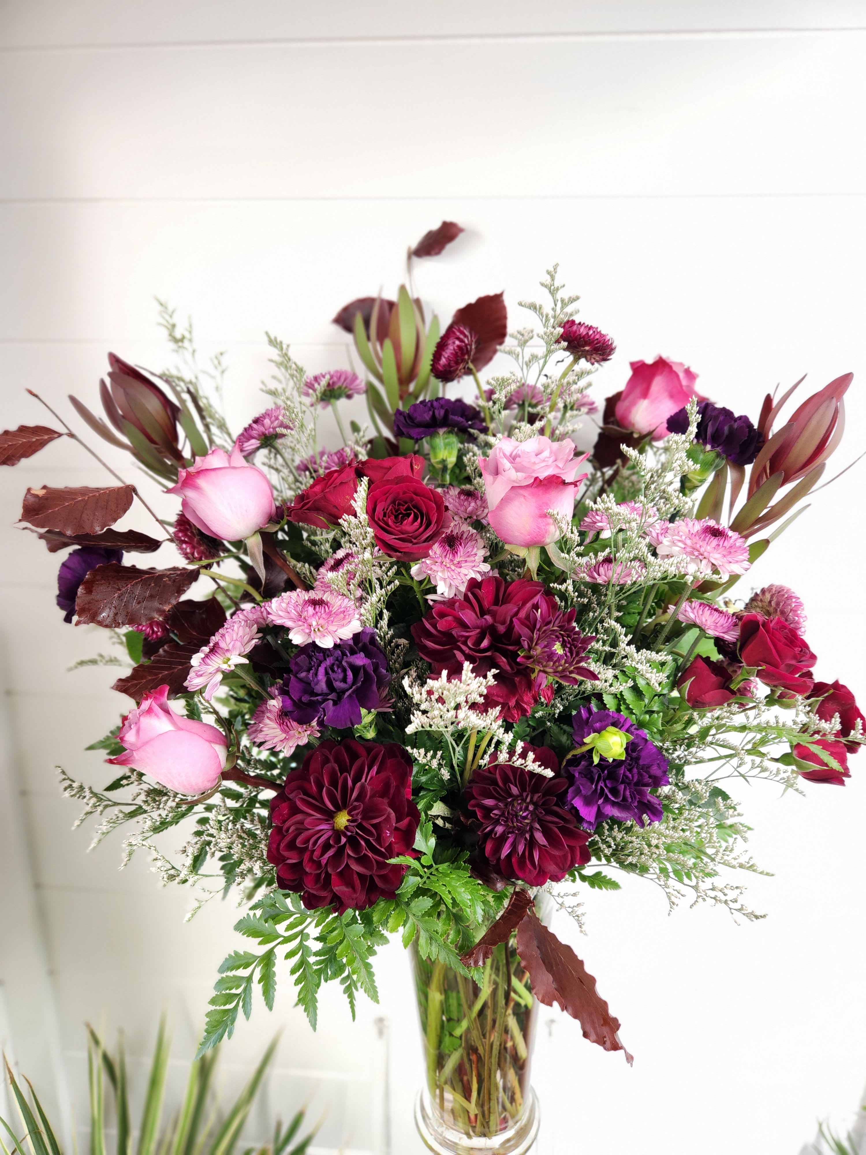 Sugar Plum  - A mix of burgundy &amp; purple flowers including Roses, Dahlias, carnations, and other complimentary flowers and greenery.   ***Limited quantity ***substitutions may apply**** 