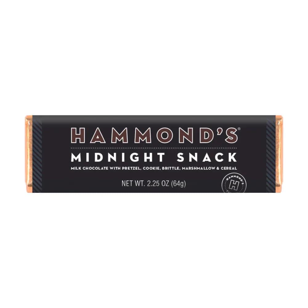 Hammond's Midnight Snack Chocolate Bar - Satisfy your late-night cravings with Hammond's Midnight Snack Chocolate Bar! This delicious treat combines the perfect combination of pretzels, cookies, brittle, marshmallow, and cereal, all enrobed in creamy milk chocolate. Perfect for those midnight munchies, this snack has everything you crave in one convenient bar. Indulge in the ultimate late-night snack with Hammond's Midnight Snack Chocolate Bar today! OU-D Kosher 2.25 oz. Chocolate Bars Please note: Made with gourmet premium ingredients and fun flavors! Manufactured in a facility that processes egg, milk, mustard, peanuts, sesame, soy, sulfites, tree nuts, and wheat.