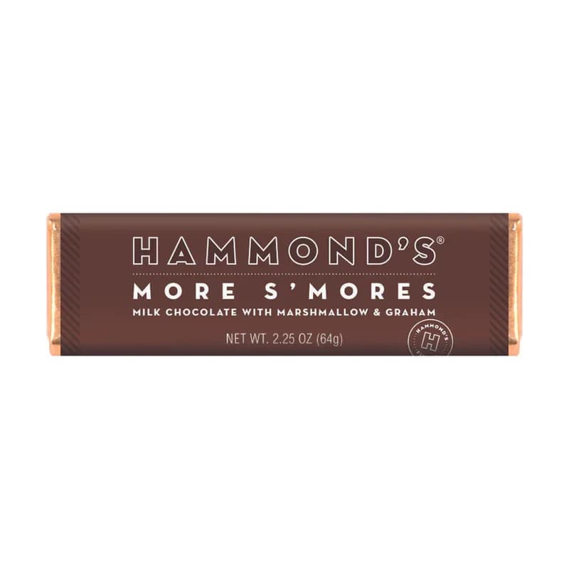 Hammond's More S'Mores Chocolate Bar - Get your s'mores fix anytime with Hammond's Milk Chocolate S'mores Candy Bar! Made with creamy milk chocolate, gooey marshmallows, and crunchy graham cracker bits, this candy bar packs all the classic s'mores flavors into one convenient treat. Perfect for satisfying your sweet tooth on the go or for sharing with friends and family around the campfire. Indulge in the irresistible combination of chocolate, marshmallow, and graham cracker with our S'mores Candy Bar!  OU-D Kosher 2.25 oz. Chocolate Bar  Please note: Made with gourmet premium ingredients and fun flavors! Manufactured in a facility that processes egg, milk, mustard, peanuts, sesame, soy, sulfites, tree nuts, and wheat.  
