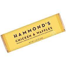 Hammond's Chicken and Waffle Chocolate Bar - Looking for a unique and tasty treat? Indulge in Hammond's Chicken and Waffles Milk Chocolate with Maple Syrup, the perfect combination of breakfast and dessert in one delicious bar. You'll feel like you're sitting at your favorite diner with a hot plate of chicken and waffles, except this time it's in the form of a chocolate bar. With the rich flavor of milk chocolate and the sweetness of maple syrup, this bar is a breakfast-themed snack that you won't want to miss.  OU-D Kosher 2.25 oz. Chocolate Bars Please note: Made with gourmet premium ingredients and fun flavors! Manufactured in a facility that processes egg, milk, mustard, peanuts, sesame, soy, sulfites, tree nuts, and wheat.