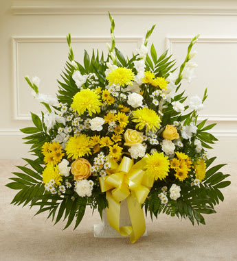 Heartfelt Tribute Floor Basket Arrangement - When dealing with the loss of a family member, friend or colleague, finding the perfect expression of sympathy can be difficult. Featuring a tasteful gathering of fresh yellow roses, white carnations and more, our heartfelt floor basket arrangement will help you convey all the comfort and support that's in your heart when words just don't seem to be enough. Floor basket arrangement of fresh yellow roses, cremones, white gladiolas, carnations, monte casino and more Appropriate for family, friends or business associates to send directly to the funeral home Our florists use only the freshest flowers available, so colors and varieties may vary Large arrangement measures approximately 32"H x 38"L Medium arrangement measures approximately 32"H x 32"L Small arrangement measures approximately 32"H x 30"L