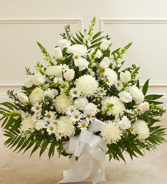 Heartfelt Tribute White Floor Basket Arrangement - Crafted from striking white blooms, our tasteful floor basket arrangement is a beautiful symbol of your care and concern in this time of sorrow. Hand-gathered with the freshest roses, mums, snapdragons and more, it's a beautiful expression of all the love in your heart as well as a touching way to remember a loved one who has passed. Floor basket arrangement of fresh white flowers Medium and large arrangements include white roses, snapdragons, spider mums and more Small arrangement includes spider mums, snapdragons, carnations and more Appropriate for family, friends or business associates to send directly to the funeral home Our florists use only the freshest flowers available, so colors and varieties may vary Large arrangement measures approximately 32"H x 40"L Medium arrangement measures approximately 32"H x 38"L Small arrangement measures approximately 32"H x 32"L