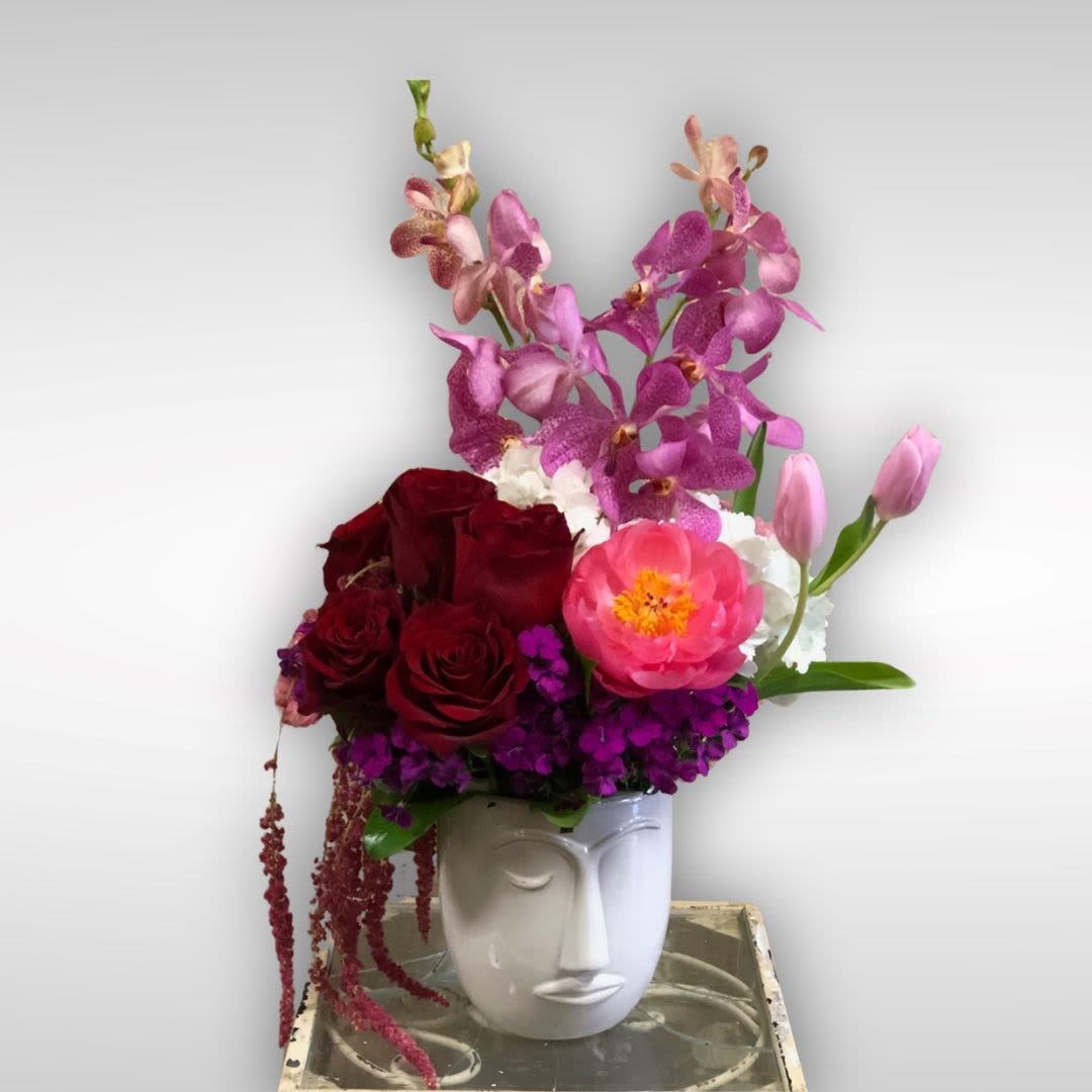 Celebration of Women's Month - Recipe: Fuschia Dendrobium Orchids, Red Roses, Pink Peony, White Hydrangae, Pink Tulips, Sweet William, Amaranthus in an face pot. Availability: Seasonal peonies Design View: Symmetric Front Facing View Photo shown: Standard 