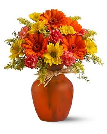 Autumns Golden Lights - Go for the golden with sunny orange and yellow flowers in a orange vase! You won't find a more cheerfully charming party gift. Beautifully affordable, too. Orange gerberas and carnations, yellow daisy spray chrysanthemums and solidago, aster, and seeded eucalyptus are delivered in an orange vase adorned with raffia.  Please note the bouquet pictured reflects our original design.  If the exact flowers or container in this arrangement are not available, we will create a beautiful bouquet with the freshest available flowers and closest available vase.