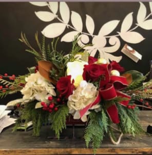 Candle Lit Christmas - Table centerpiece incorporating a white battery operated candle with real looking flame, fresh cut flowers, artificial hydrangeas, and beautiful seasonal greens 