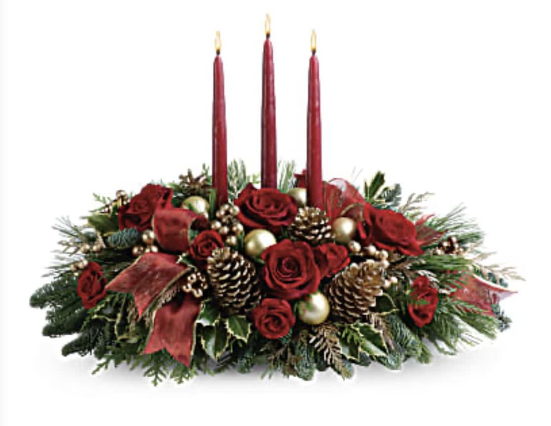All is bright - All is calm, all is bright…well, at least we can promise the latter with this luminous arrangement! Gather family and friends together for a holiday meal around this traditional Christmas centerpiece featuring pinecones, holly, noble fir and Christmas candles. 'Tis the season to shine! A fresh centerpiece of holly, noble fir, white pine, flat cedar, roses and spray roses is decorated with golden berries, Christmas ornaments, pinecones and three red taper candles. A sheer, gold-edged organza ribbon adds to the opulence. Orientation: All-Around