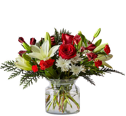 Holiday Vacation - Pack your bags for a relaxing escape with this Holiday Vacation Bouquet. Experience a floral getaway full of ivory lilies and red carnations and feel refreshed to ring in the New Year.