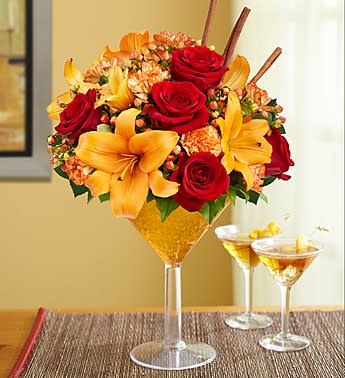 Pumpkin Spice Martini - Our fresh take on the popular cocktail gets shaken up with a new recipe! Rich roses, lilies, mini carnations and more are hand-arranged by our expert florists in an oversized keepsake margarita plastic glass. Add sweet cinnamon sticks and bronze crystal accents to really spice things up for birthdays, get-togethers or just because. This Floral drink will be created in a plastic margarita or martini glass vase.