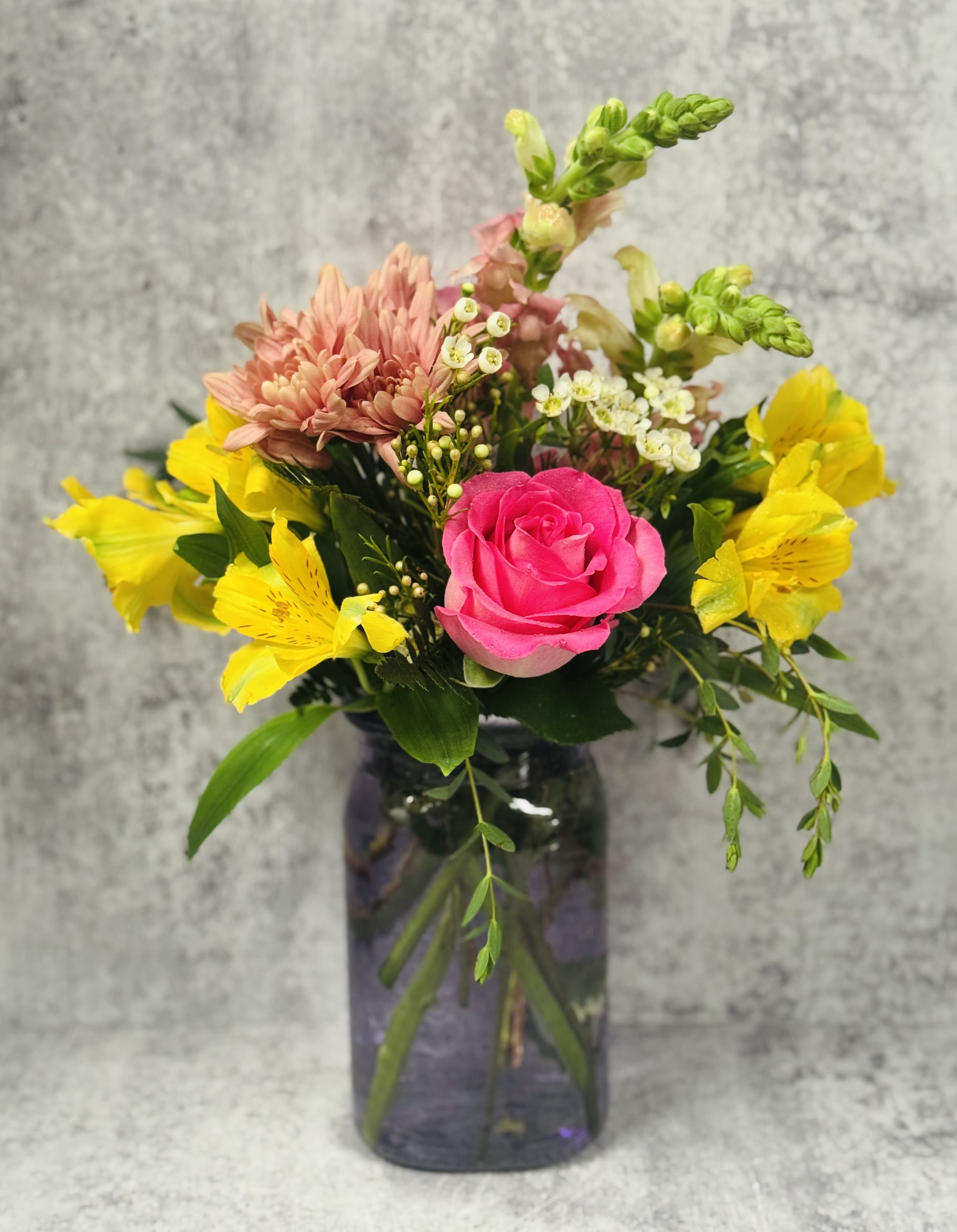 Sherbet Sunrise - All the colors of sherbet making a debut in a hammered vase.  Roses, Snapdragons, daisies, alstromeria and premium filler &amp; greens make this a delicious choice for your recepient!