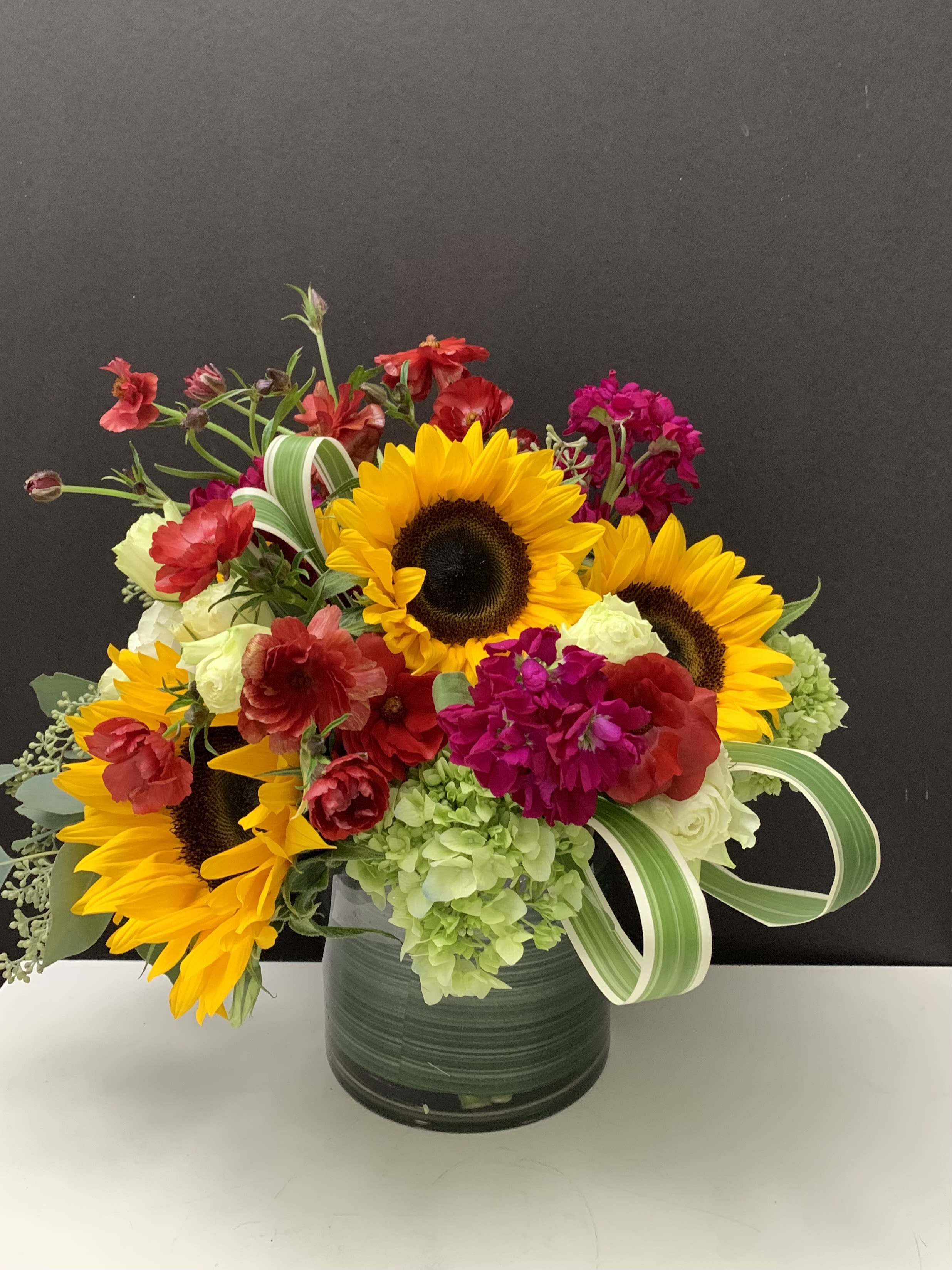 Yellow and Red  - Sunflowers, Hydrangeas,, green in 6”x 6” cylinder glass vase 