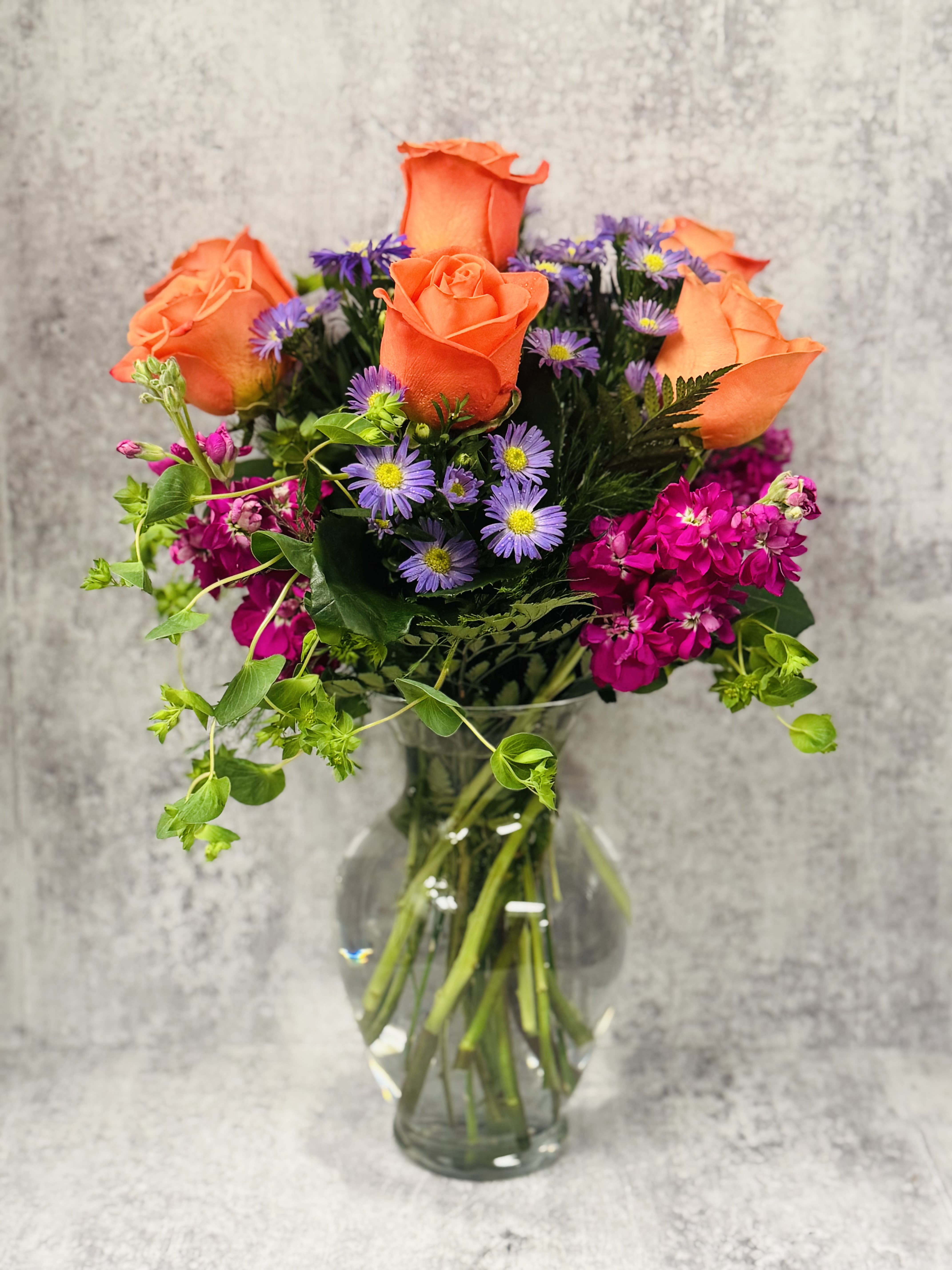 Life of the Party  - Celebrate good times with this lively bouquet. The arrangement includes roses, stock and other seasonal blooms.  This is the perfect gift for Mother's Day, Birthday, or Just Because. APPROXIMATE DIMENSIONS: 12&quot; D x 15&quot;H  Please note picture shows colors and flowers that may not be available at time of your purchase but we will substitue with similar colors and/or flowers for a beaautiful arrangement.