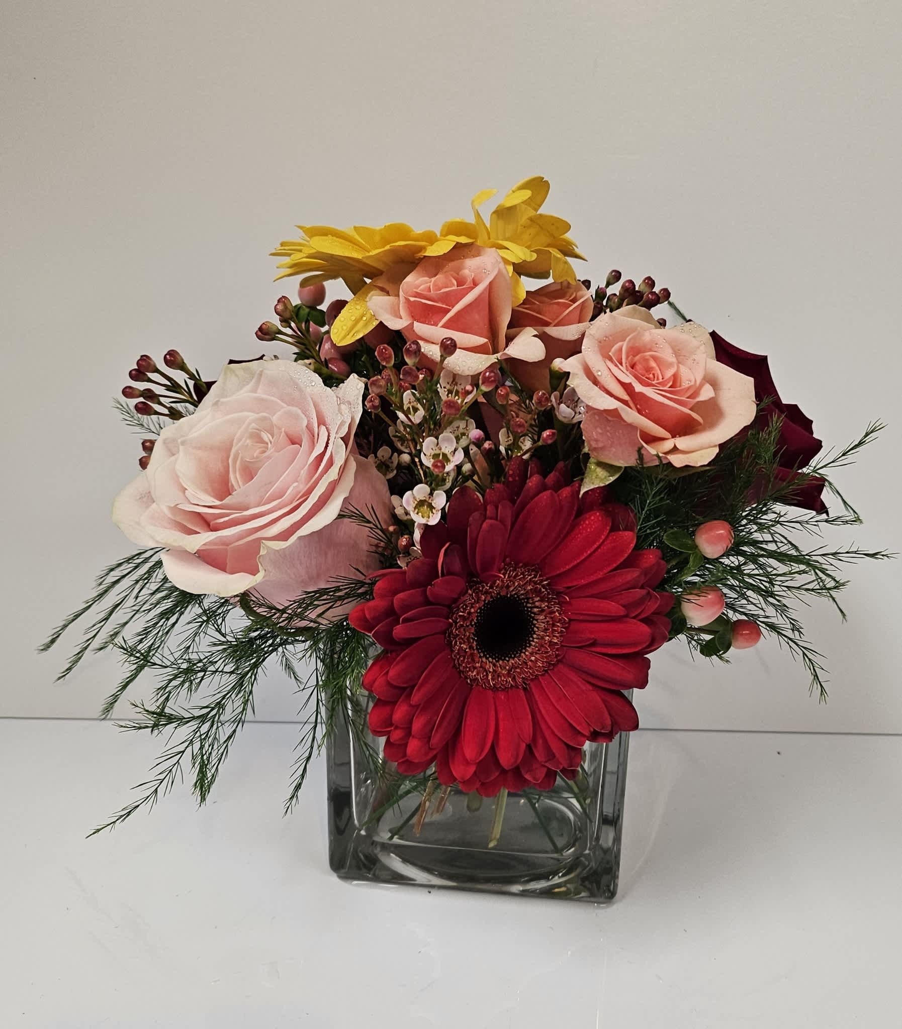 Dazzling Delight - Delight someone special, including yourself, today! Featuring in season roses, Gerbera daisy, red hypericum or seasonal filler and more!  Designers choice if flowers are not available!