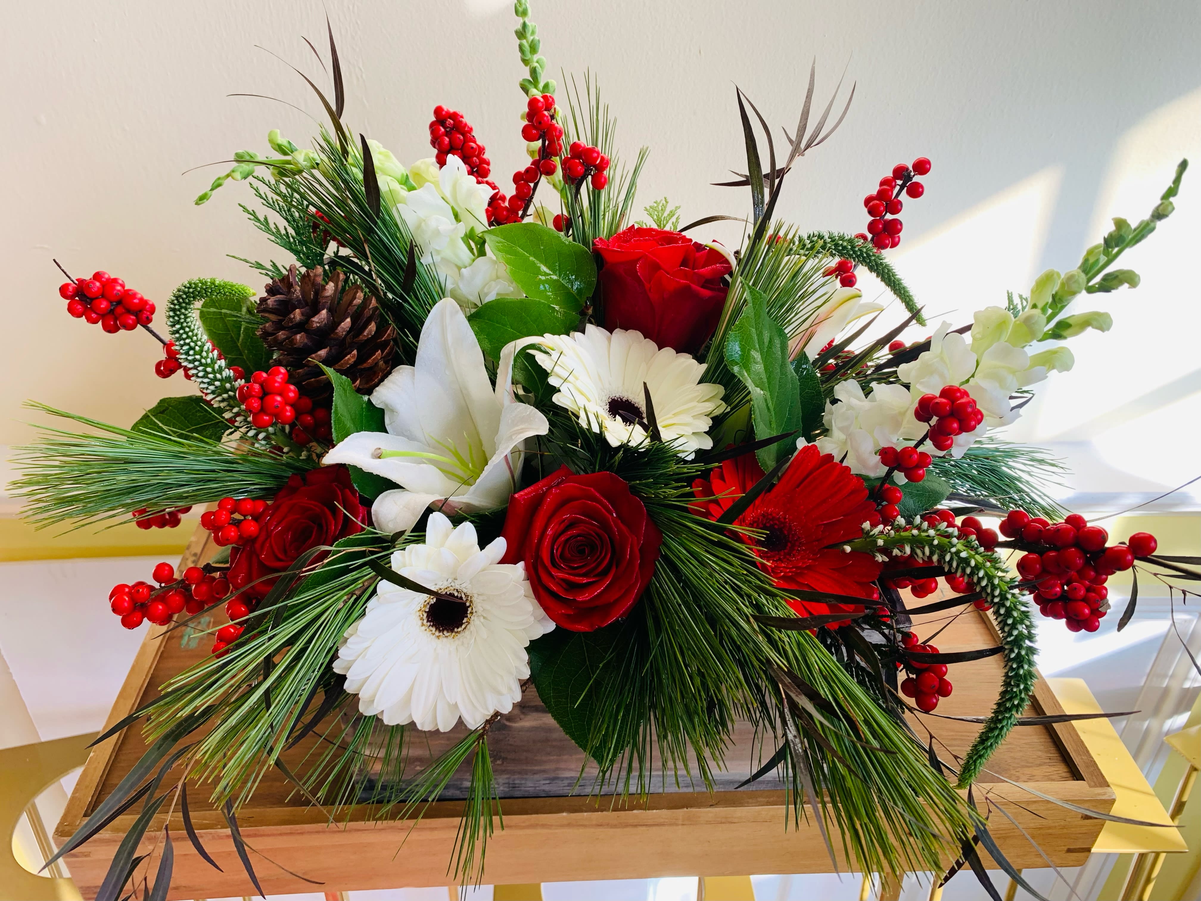 DESIGNER'S CHOICE CHRISTMAS BOX - Festive red and white flowers, winter greens and berries in a wooden box. Makes a great centerpiece or gift! **Please understand that there is an industry shortage and some flowers may be substituted- but always to value!** 
