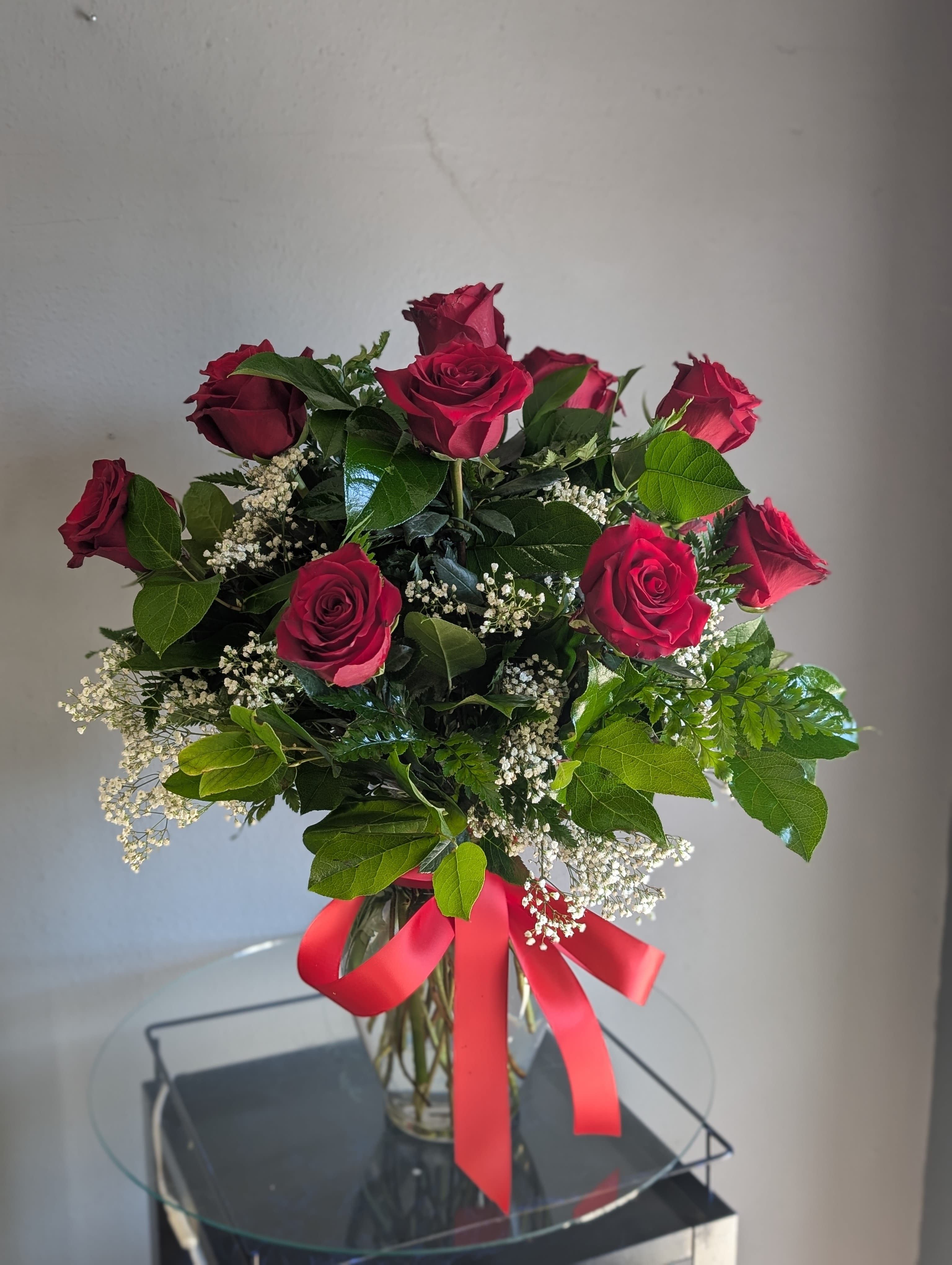 1 Doz Red Roses  - Classic one dozen red roses in a vase with filler and green.  Filler, vase and greens WILL vary. Life expectancy 3-5 Day depending on room temp and care of the flowers.