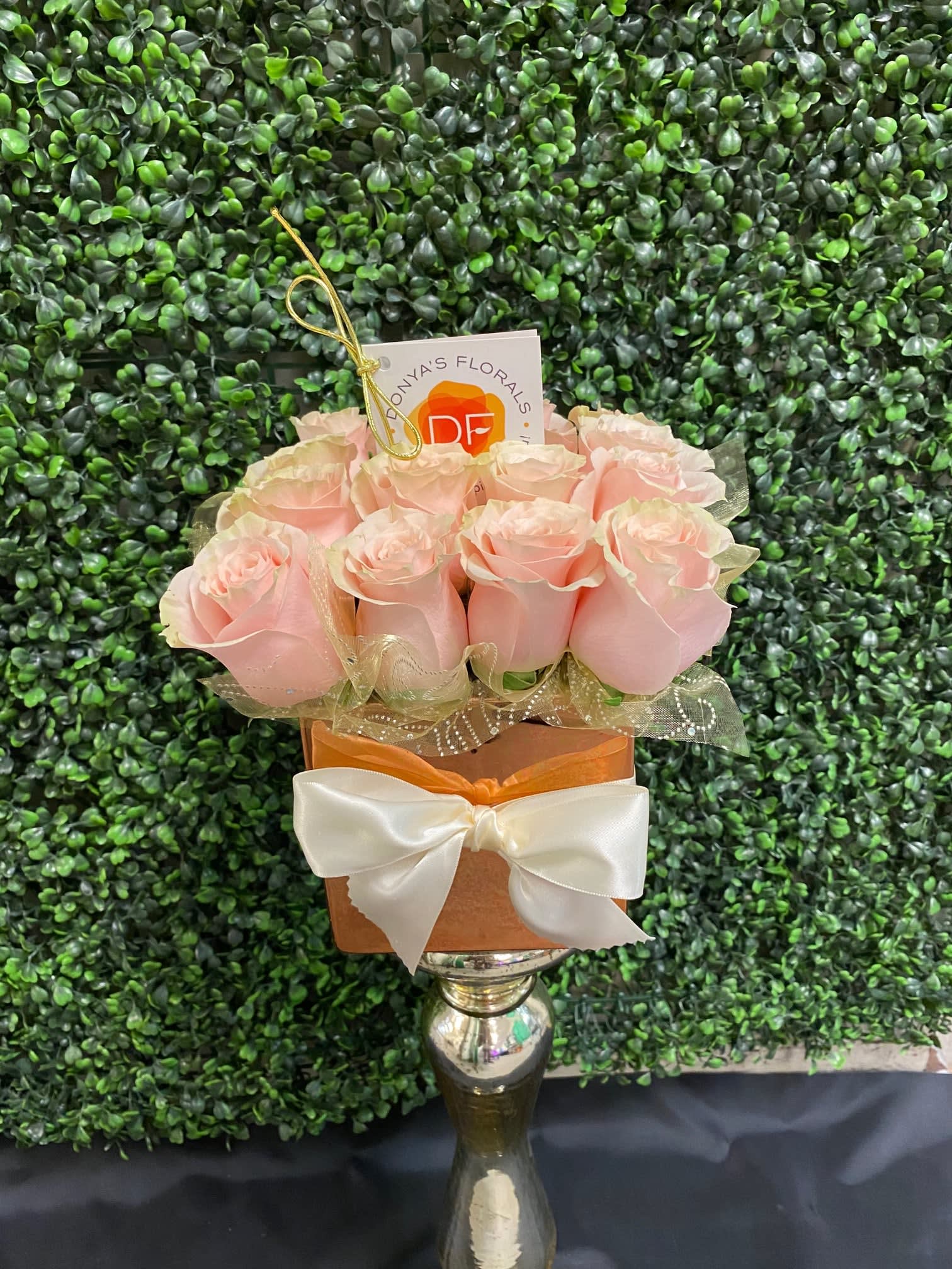 Seaside by Donya's Florals - Seaside is a beautiful blushy pink centerpiece consisting of 12-16 roses, depending on the size selected. Sized perfectly for a dining room table yet small enough to carry to the beach or park for a candlelight setting for two.