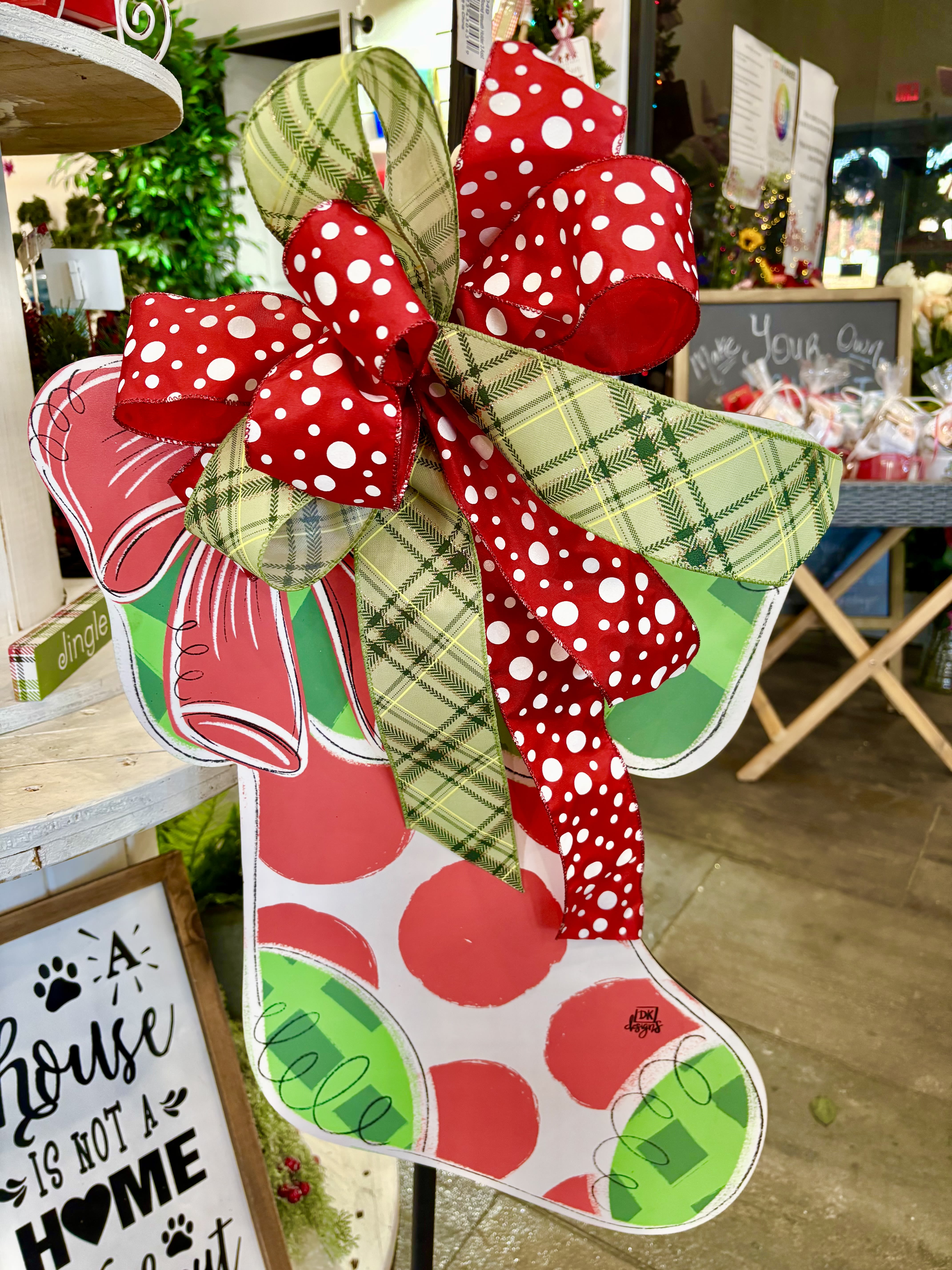 Stocking Wall/Door Hanger - Bring a pop of holiday cheer to your home with this playful Christmas stocking wall/door hanger!  Designed in bold red and green with oversized polka dots this festive piece is topped with a layered Christmas bow. Bright green and red color palette Lightweight and easy to hang Perfect for your front door, porch, entryway or office. Also makes a great gift. Approx. size 27&quot; tall x 22&quot; wide Material: lightweight painted composite.