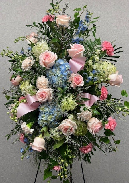 Pinks/Blues Standing Spray  - Absolutely beautiful standing spray piece! In this spray are light pink roses, blue hydrangeas, blush and pink carnations, white hydrangeas, white and blue delphinium, beautiful misty blue, and all the green fillers! Can be customized as well! 