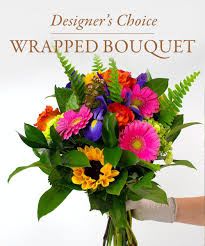 Wrapped Bouquet - A mixture of seasonal flowers with greenery in decorative wrapping. (No vase included.)