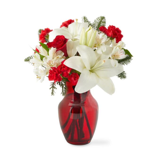 Holiday Season Bouquet (FTD) - Pristine white lilies and ruby red roses are a classic holiday pairing! A perfect gift for any occasion, all winter long! Approximately 12 inches wide and 14 inches tall for the Standard size.