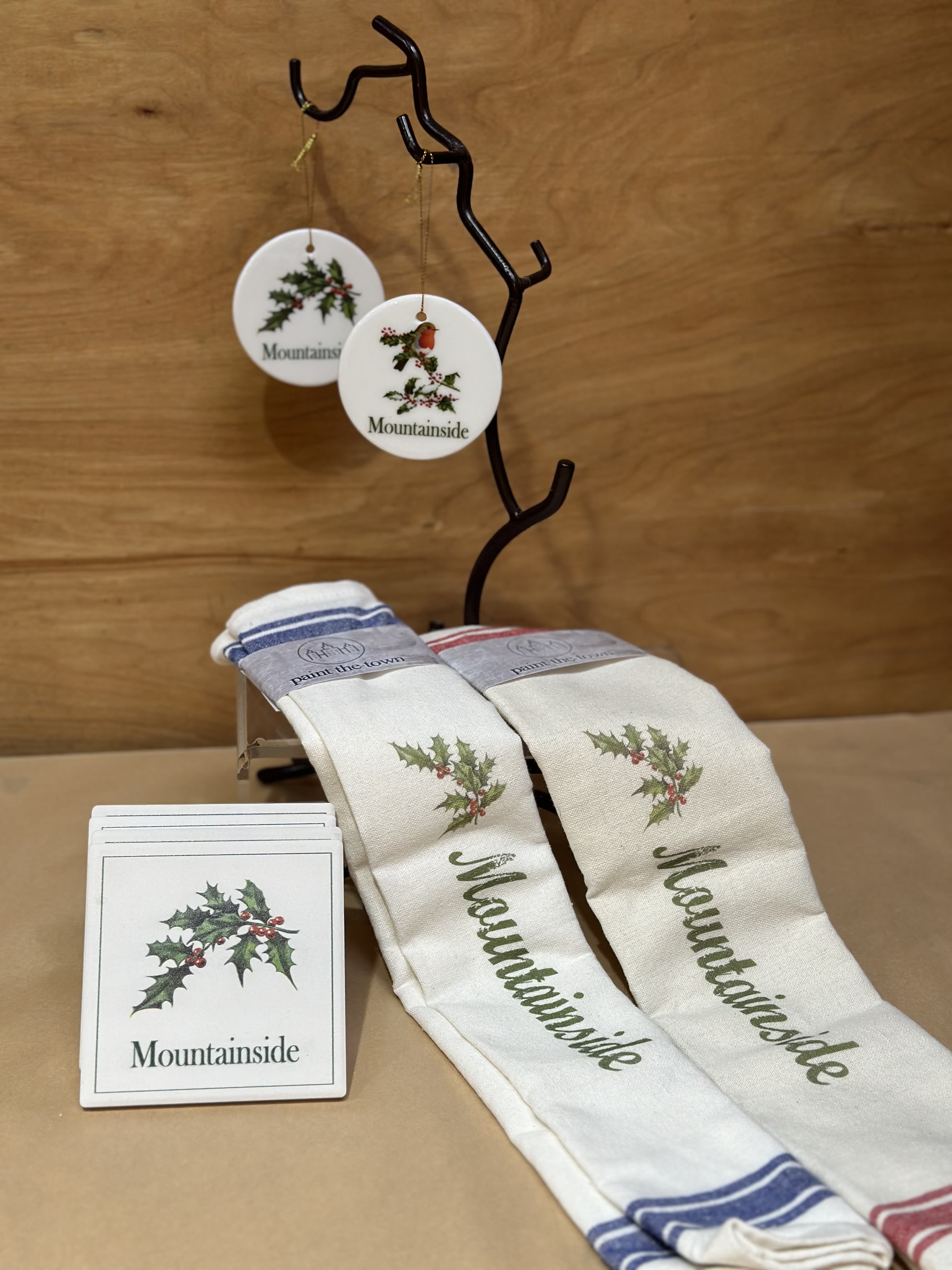 Christmas in Mountainside  - Two Holiday themed hand towels paired with 4 tile coasters and 2 ceramic ornaments  * Linen Hand Towel is 28&quot; long and 18&quot; wide and are made of 100% cotton material * Coasters are made out of absorbent tile and have a full corked back to protect your furniture. They measure 4&quot; x 4&quot; and are 1/4&quot; thick.  * 2.875” Diameter White glass Ornament