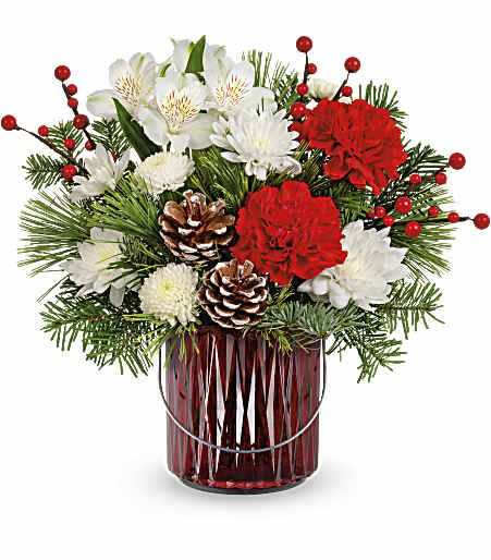Luminous Charm Bouquet - This charming and bright bouquet of red roses is artfully arranged in a ruby red lantern vase with a silver handle. It doubles as a lovely candleholder for future holiday seasons! Approximately 13 1/2 inches wide and 12 1/2 inches tall for the Standard size. 