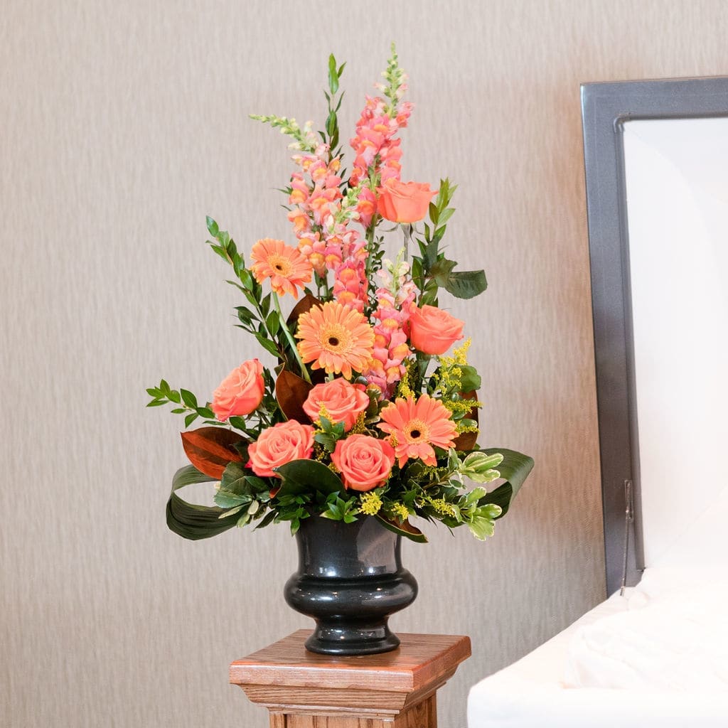 Apricot - A vibrant orange traditional arrangement is a sweet way to express the memories of the one who put a smile on your face.  Approximate dimensions: 30&quot; T X 17&quot; W 